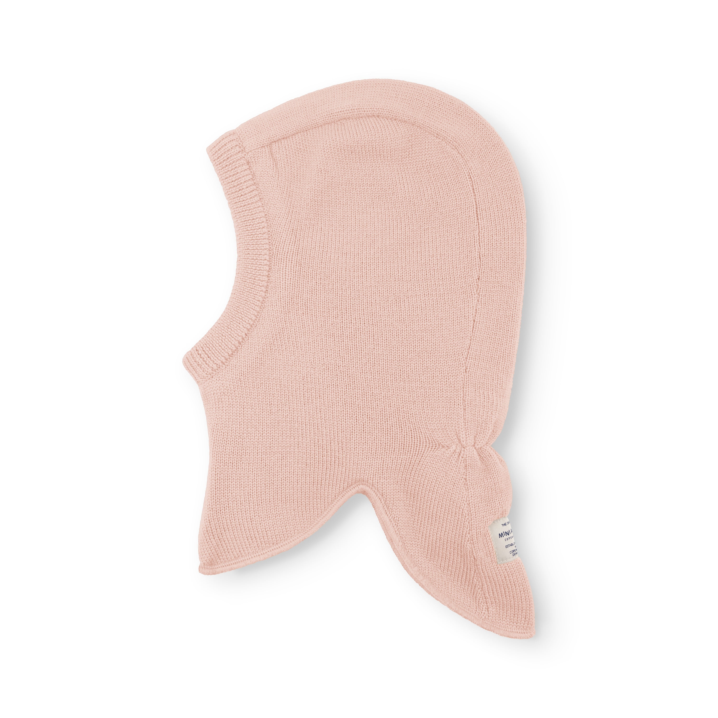 MATJORK balaclava in soft pink merino wool shown flat, revealing the ribbed knit texture, face opening and extended neck panel that tucks beneath a jacket collar for layering.