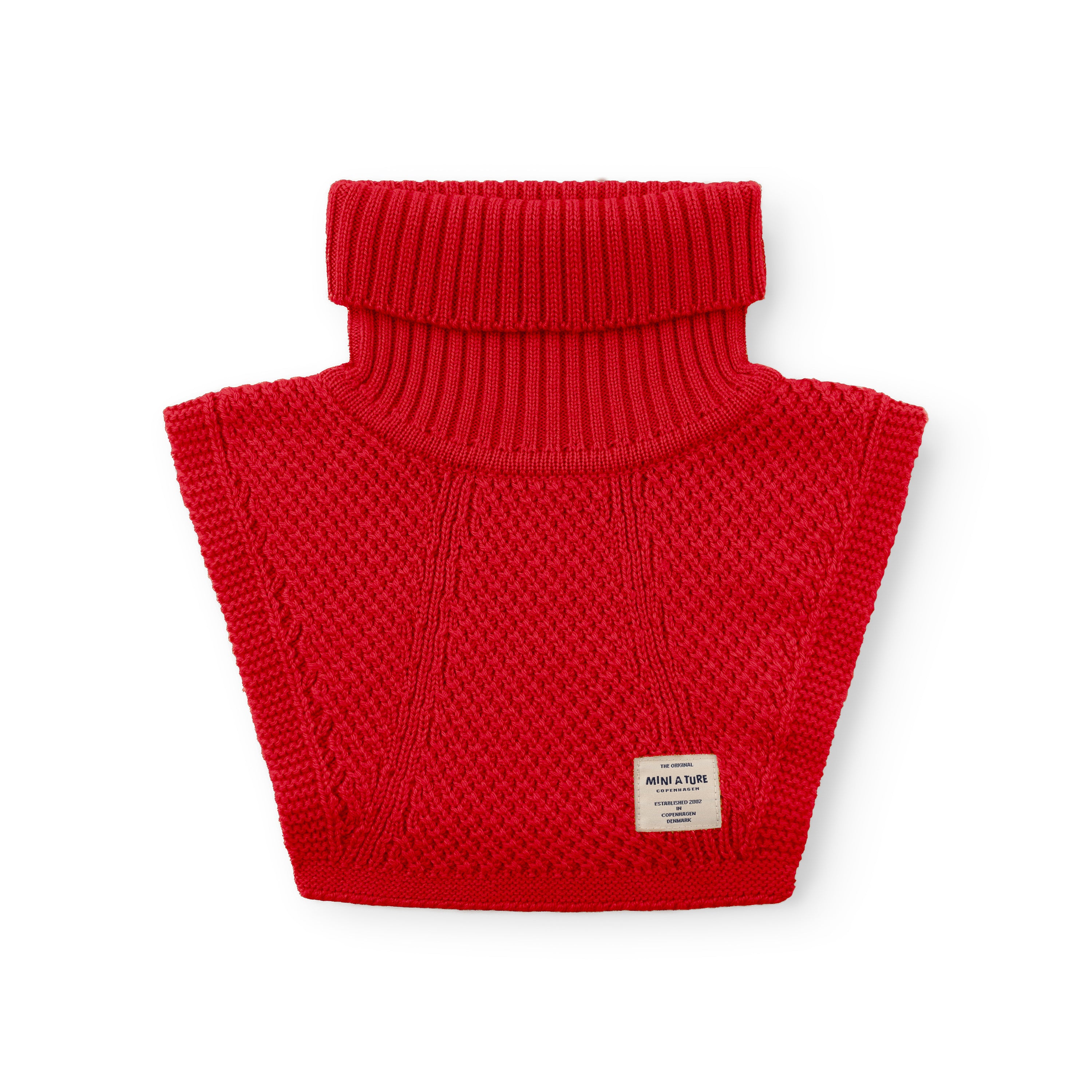 MATTAYLER neckwarmer in red merino wool, photographed flat against a white background, showing the wide ribbed high neck and moss-stitch textured body panels with a MINI A TURE label at the lower centre.
