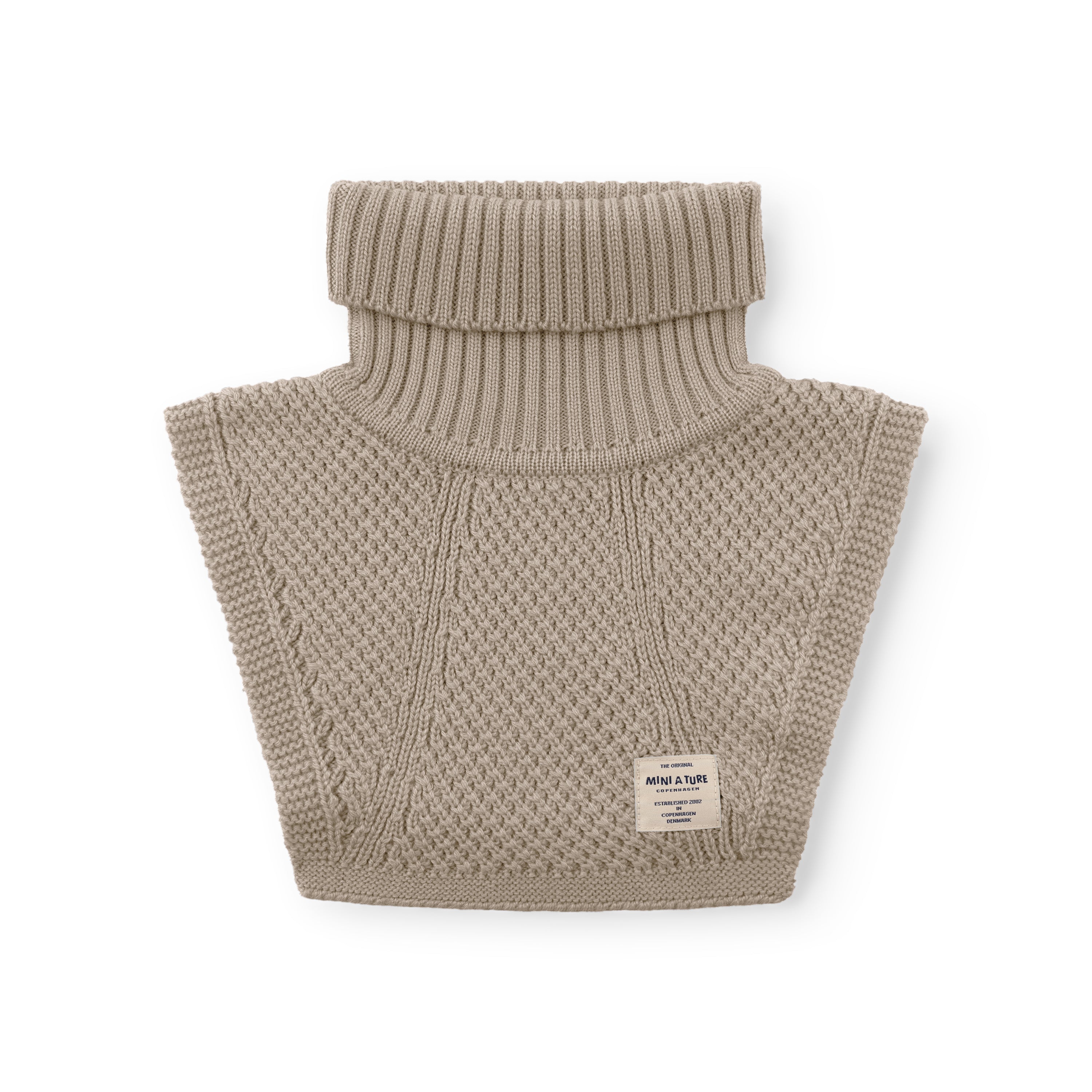 MATTAYLER neckwarmer in beige merino wool, photographed flat against a white background, showing the wide ribbed high neck folded down and moss-stitch textured front and back panels with a MINI A TURE label at the lower right.