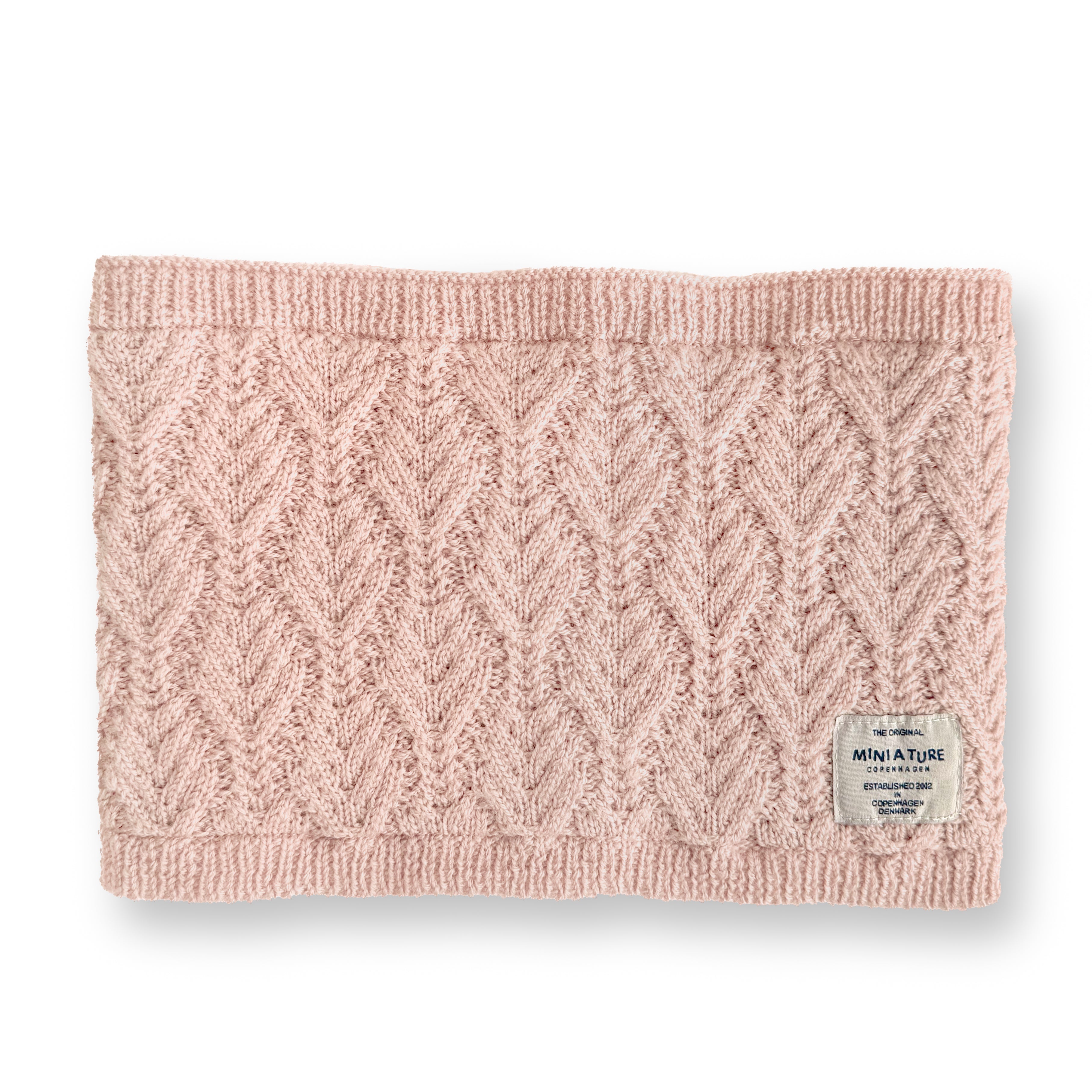 MATGOI fleece lined neckwarmer in soft blush pink merino wool with chevron knit texture, ribbed top and bottom edges, and a woven MINI A TURE label at the lower right.