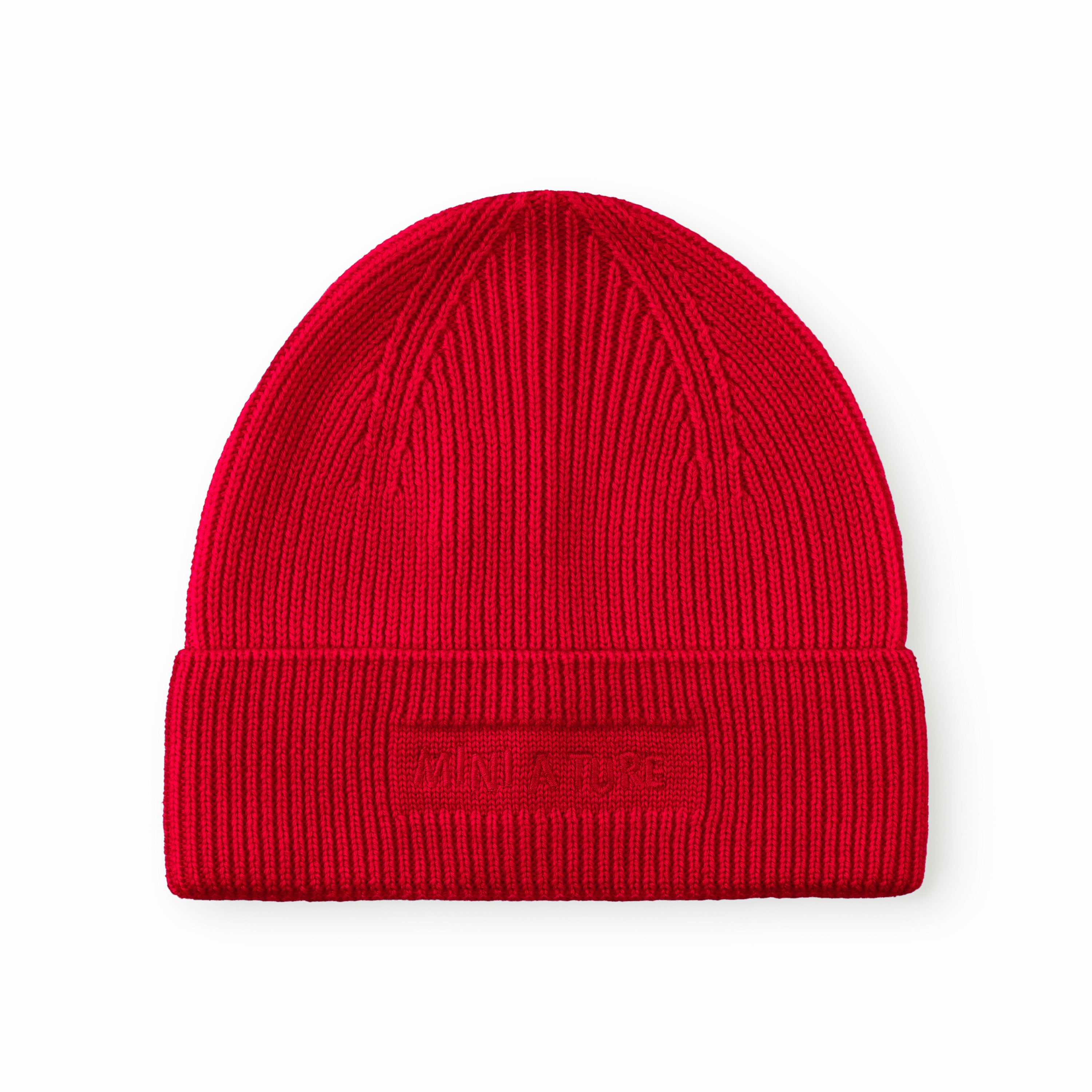 MATBOJE beanie in bright red merino wool with a ribbed knit and fold-up brim, displayed flat against a white background showing the embroidered logo.