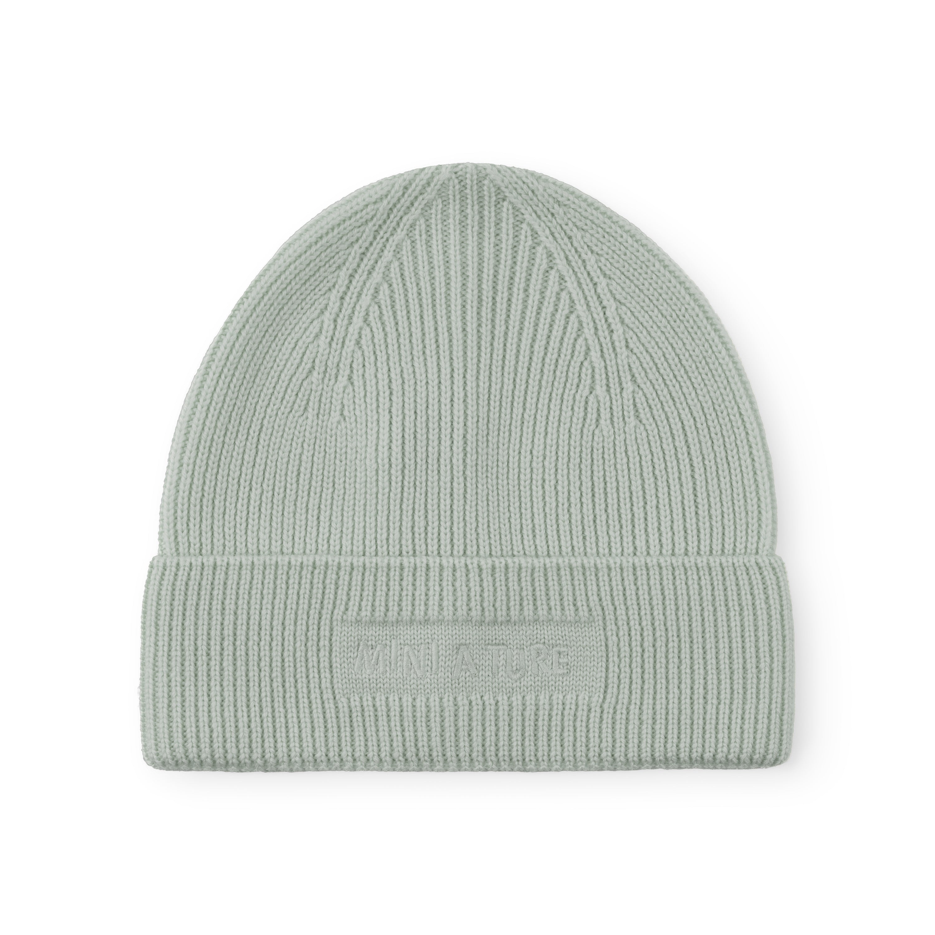 MATBOJE beanie in pale sage merino wool with a fold-up brim and embroidered logo, displayed flat against a white background.