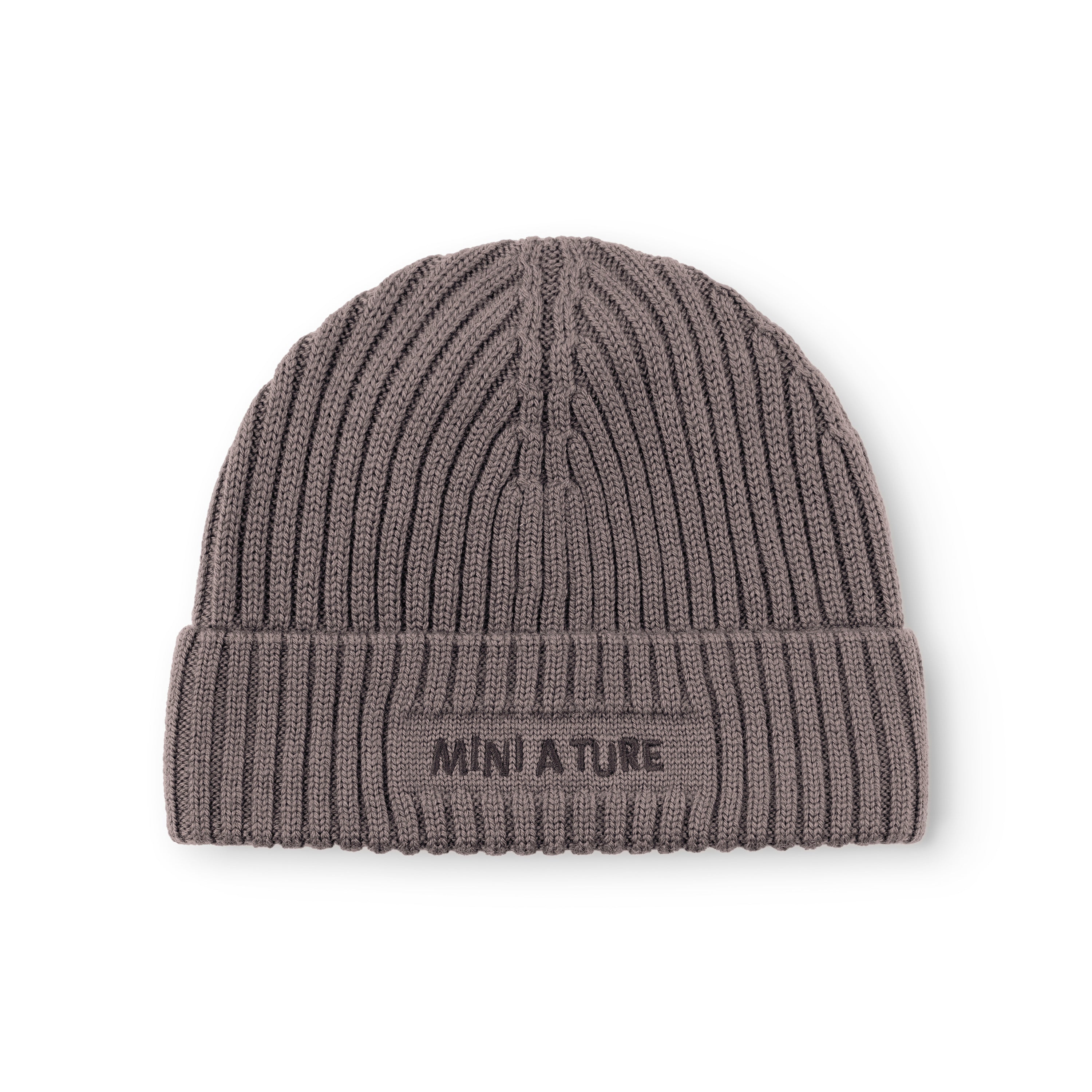 MATBOJE fleece lined beanie in charcoal grey merino wool with the fold-up brim worn in place, displaying the embroidered MINI A TURE logo and the vertical ribbed knit texture across the crown and brim.