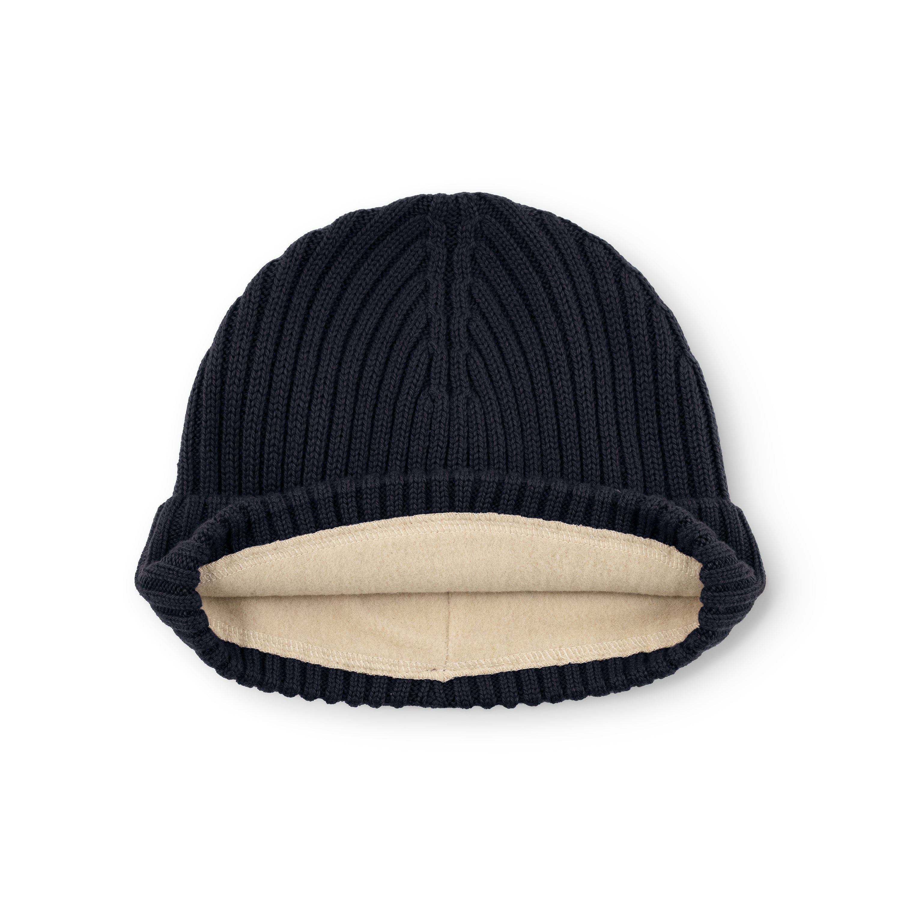 MATBOJE fleece lined beanie in navy merino wool laid flat with the fold-up brim turned back, exposing the cream recycled polyester fleece lining and the vertical ribbed knit pattern across the crown.