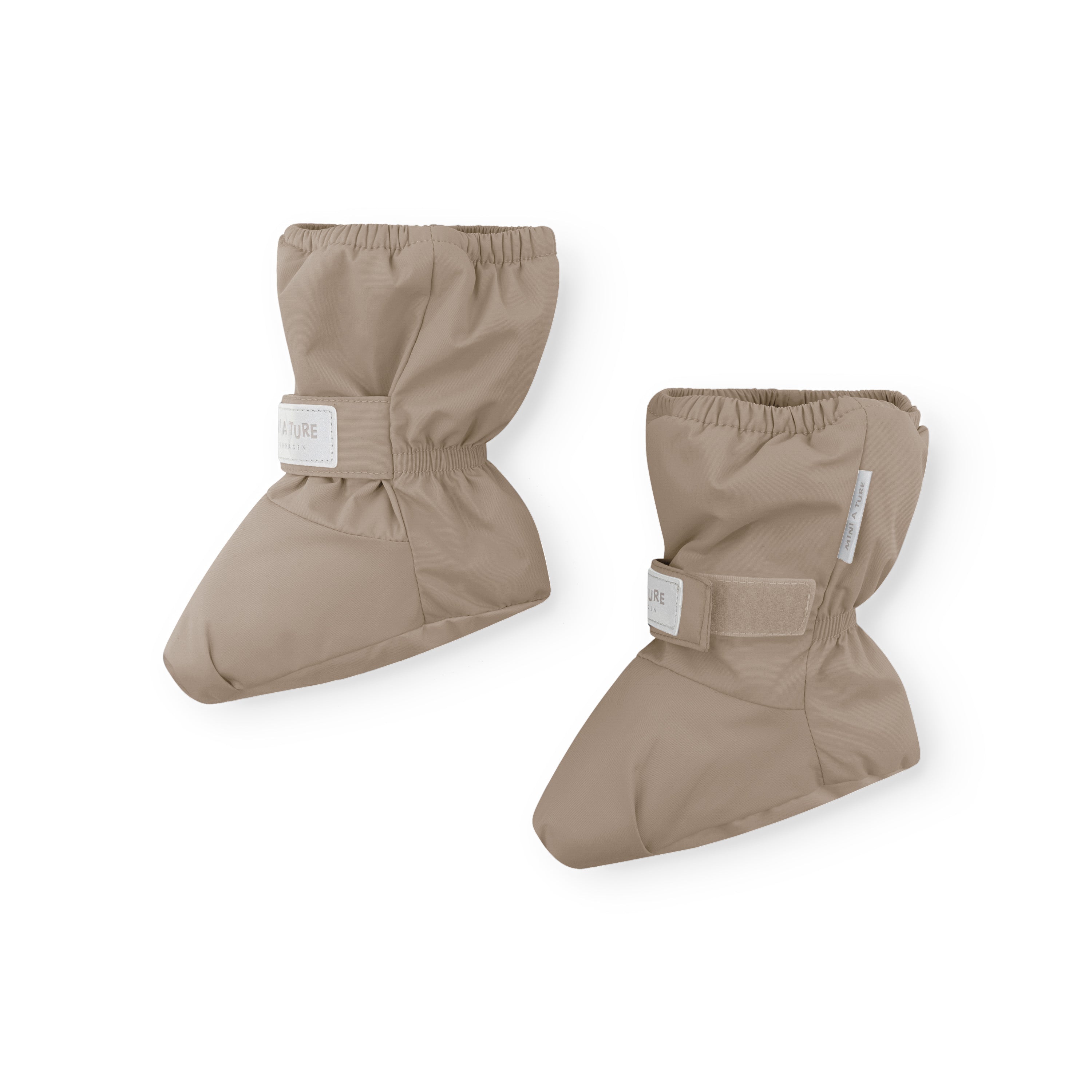 Close-up of MATWINN waterproof baby outdoor socks in neutral beige with THERMOLITE insulation, showing the velcro ankle closure and soft recycled polyamide shell designed for pram journeys and cold-weather protection.