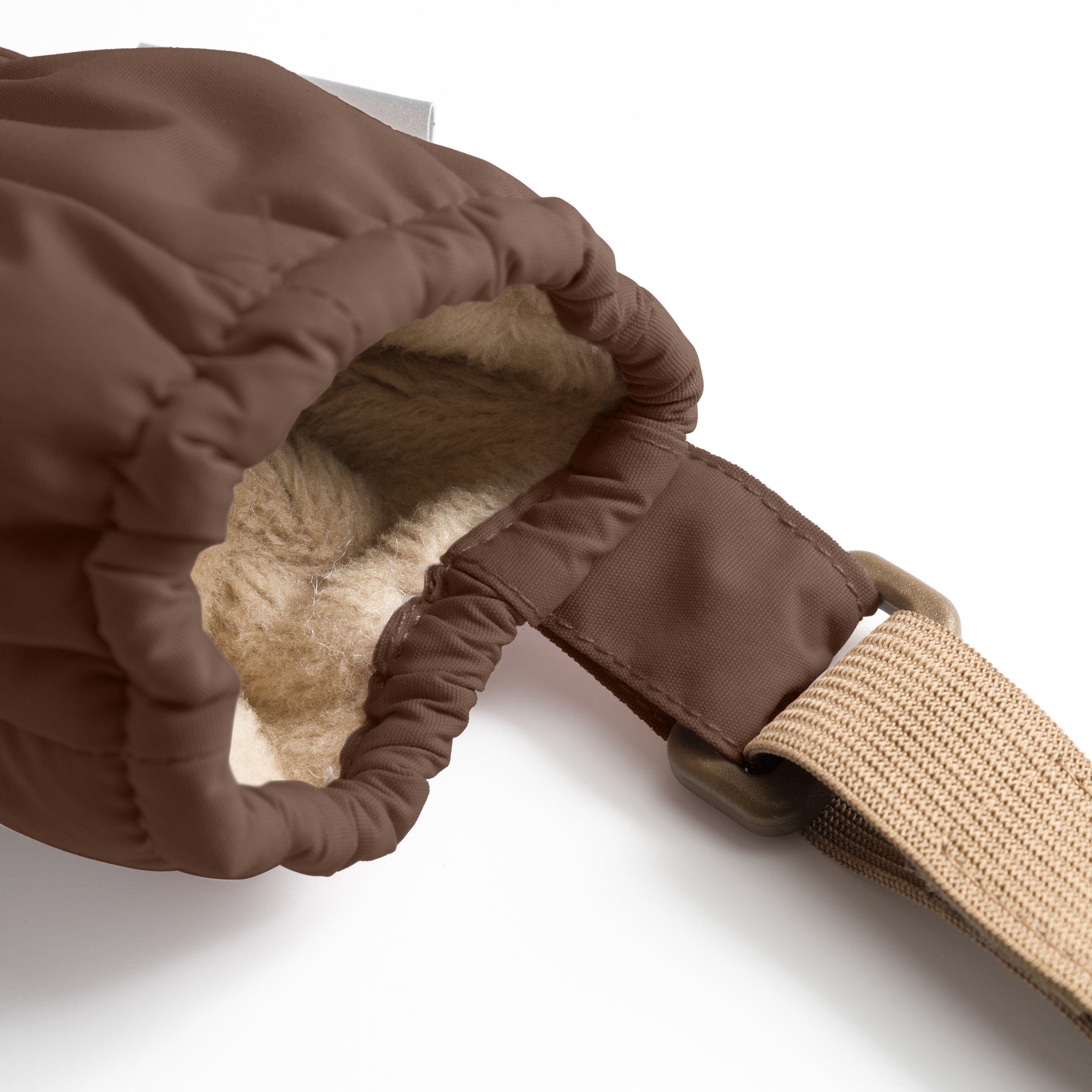 MATCORDT fleece lined mittens in warm brown shown turned inside out, revealing the soft beige fleece lining and THINSULATE padding at the interior, with the elastic gathered cuff construction visible alongside the beige velcro attachment strap and the waterproof recycled polyamide outer shell folded back.