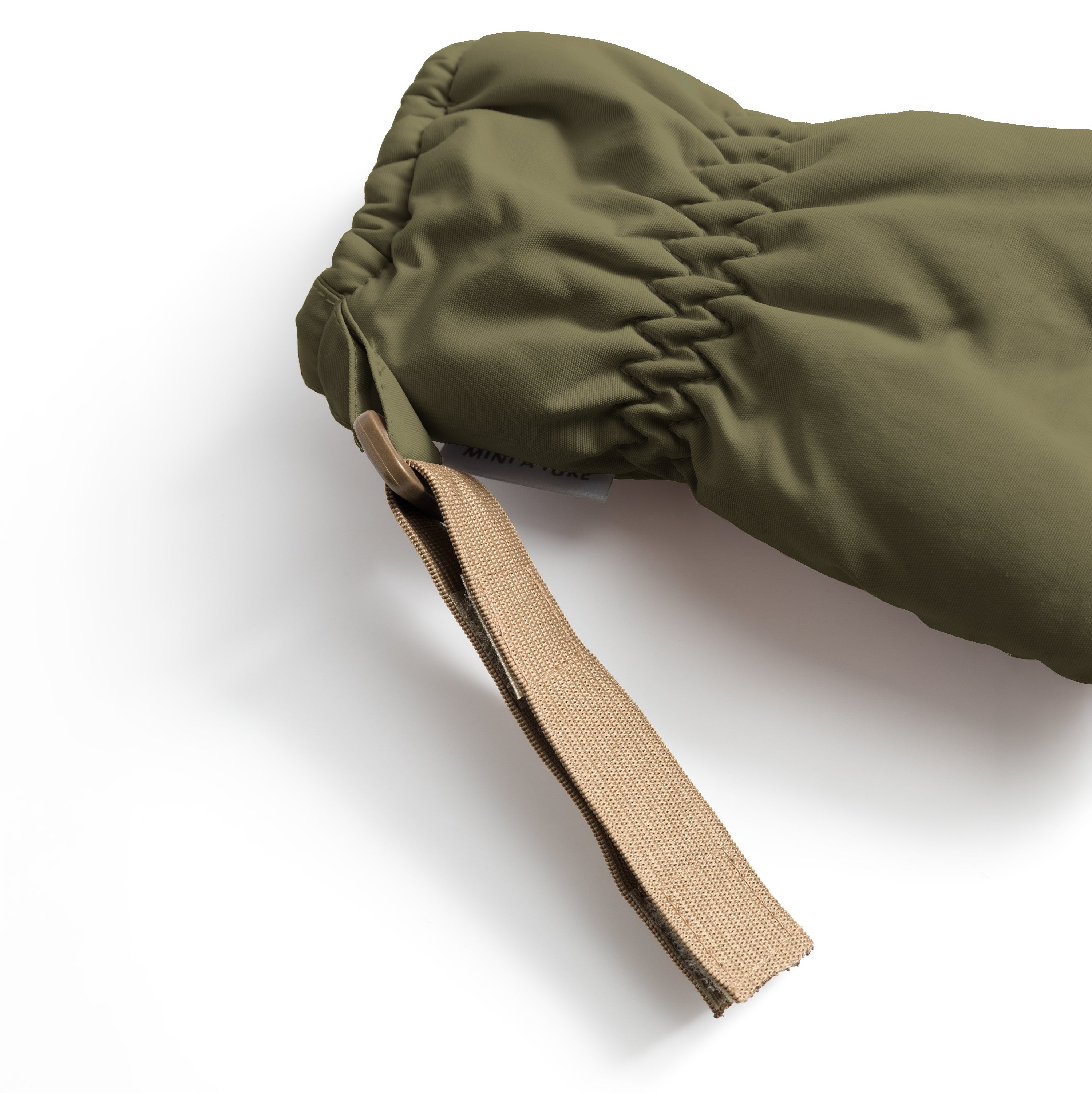 MATCORDT fleece lined mittens in olive green shown in close-up, featuring the elastic gathered cuff that seals out cold air and the extended beige velcro strap designed to attach to D-loops on MINI A TURE outerwear.