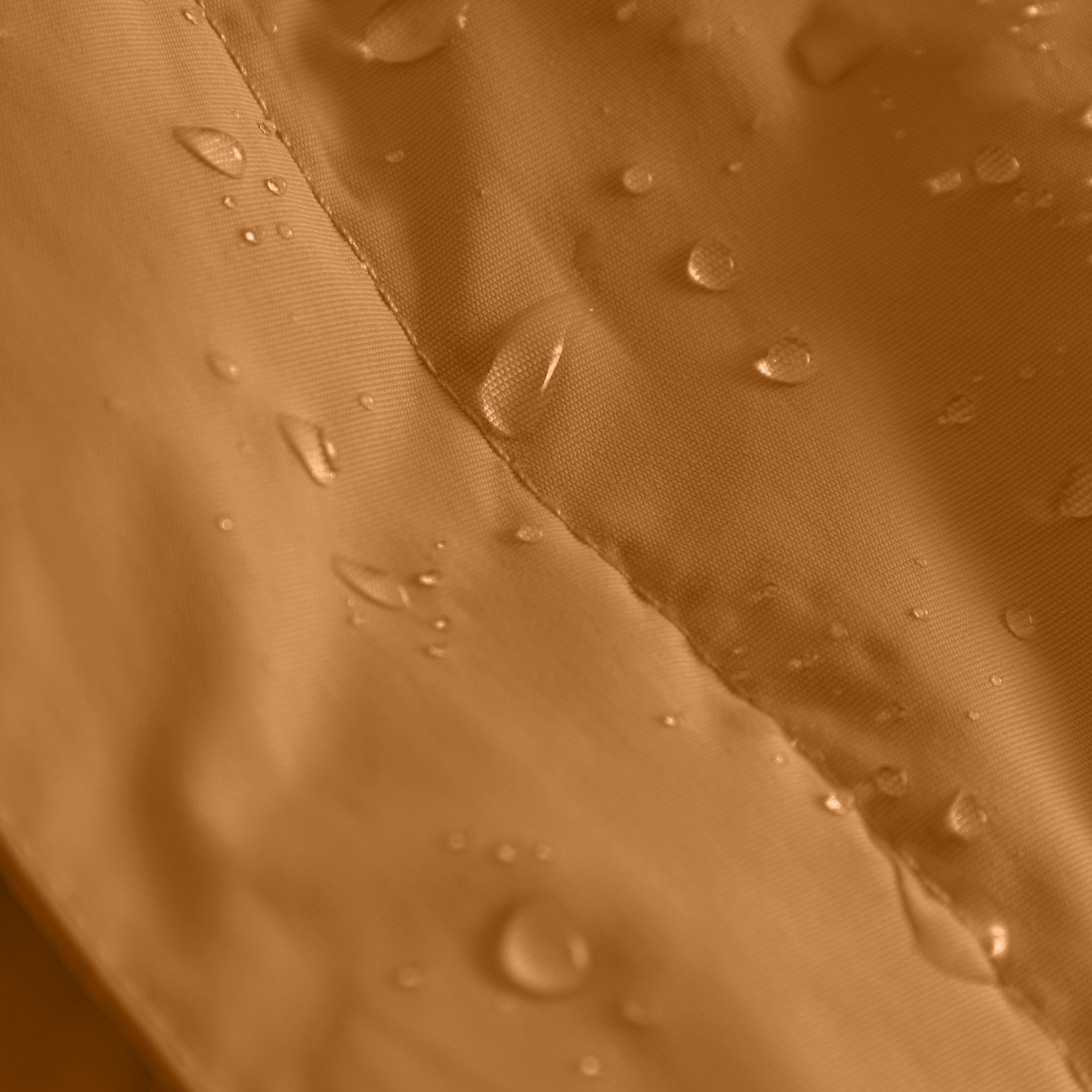 Close-up of the MATWANG fleece-lined winter jacket's waterproof recycled nylon shell in warm brown with water droplets beading on the surface, demonstrating the fluorine-free Bionic Finish Eco treatment and flat-felled seam construction.