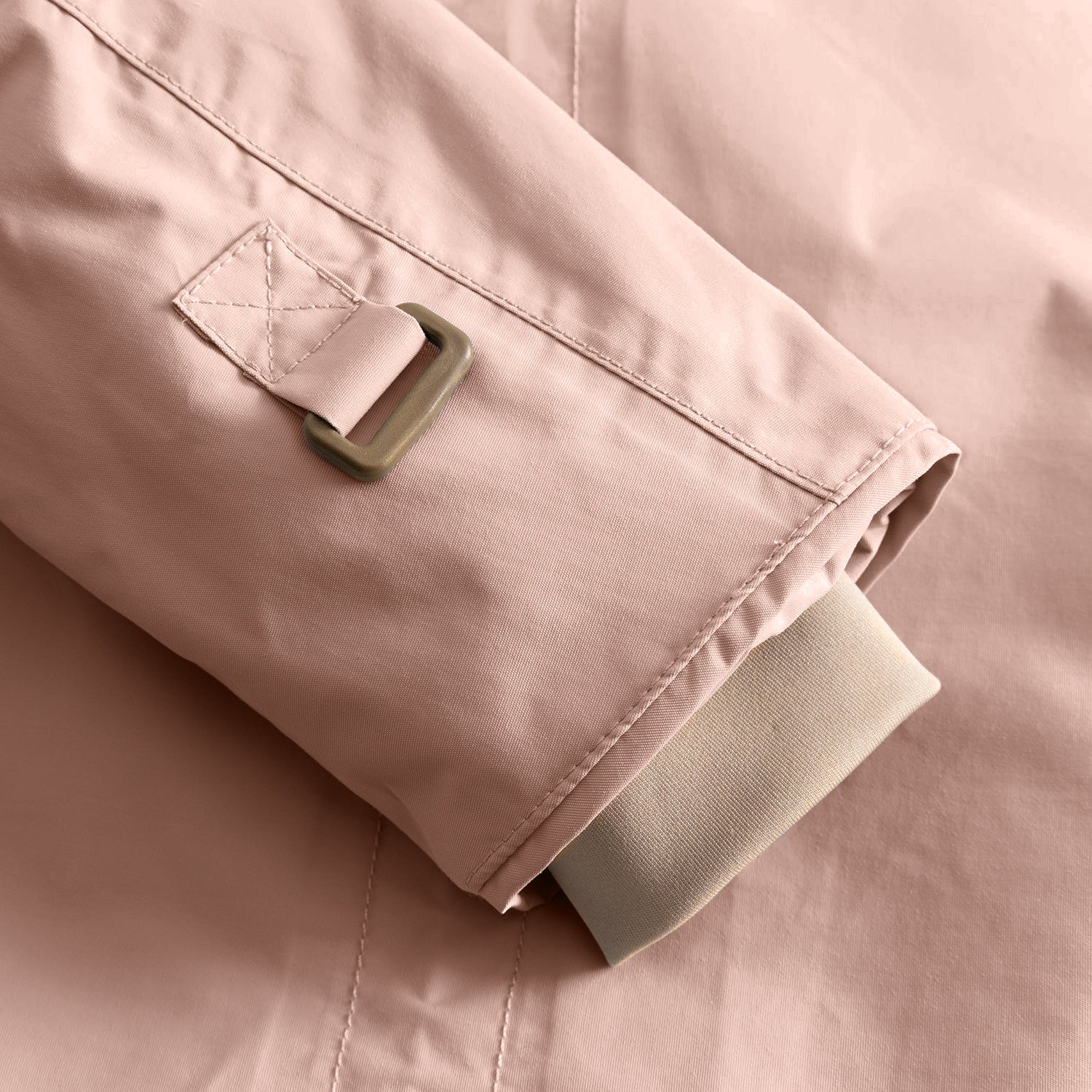 Detail of the MATWALLY fleece lined winter jacket sleeve in dusty pink, showing the adjustable snow cuff with metal D-ring and fabric tab, beige ribbed inner cuff with thumb opening and fully taped seam construction visible along the sleeve edge.