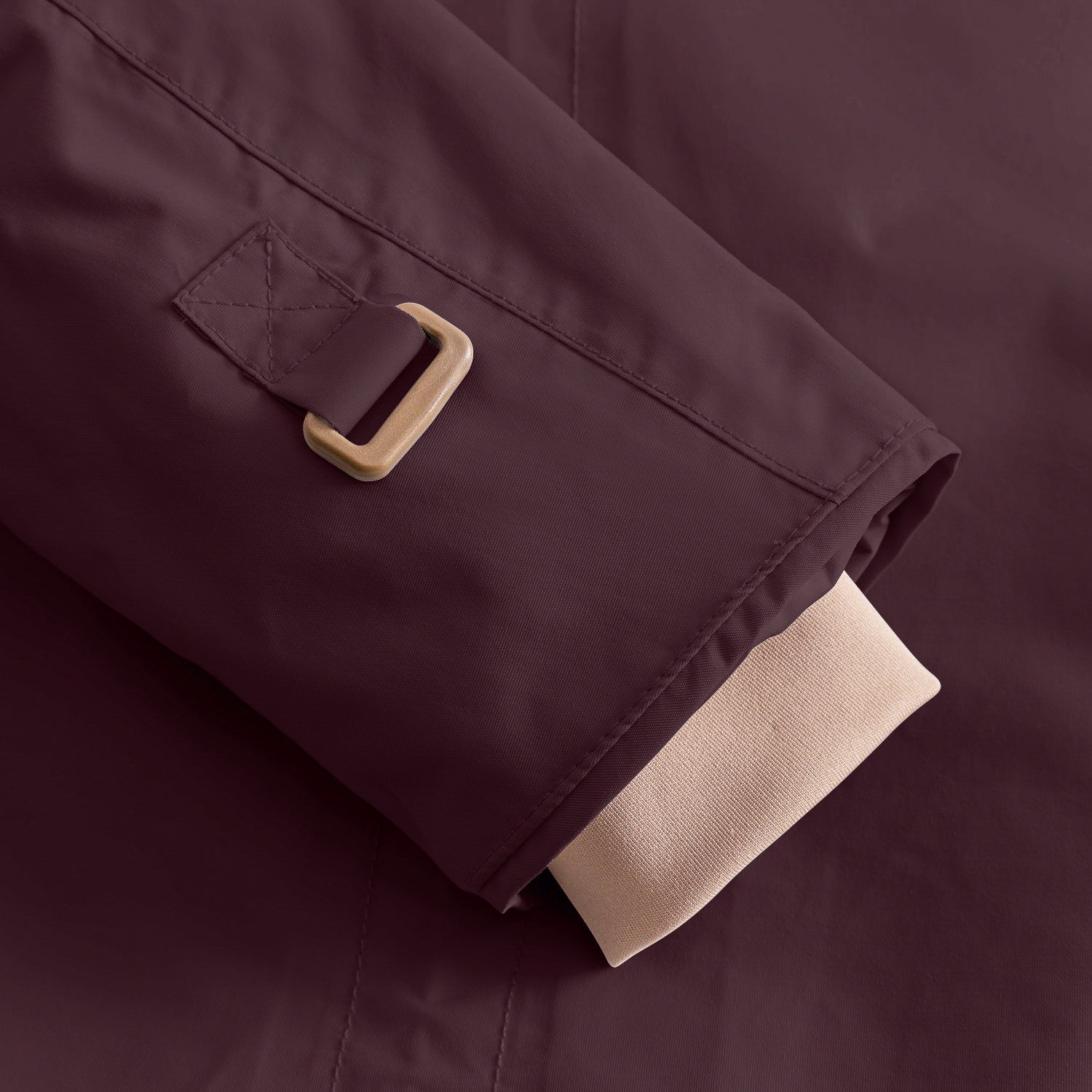 Detail of the MATWALLY fleece lined winter jacket sleeve in deep burgundy, showing the metal D-ring with fabric tab for snow cuff adjustment and the beige ribbed inner cuff with thumb opening visible at the hem.