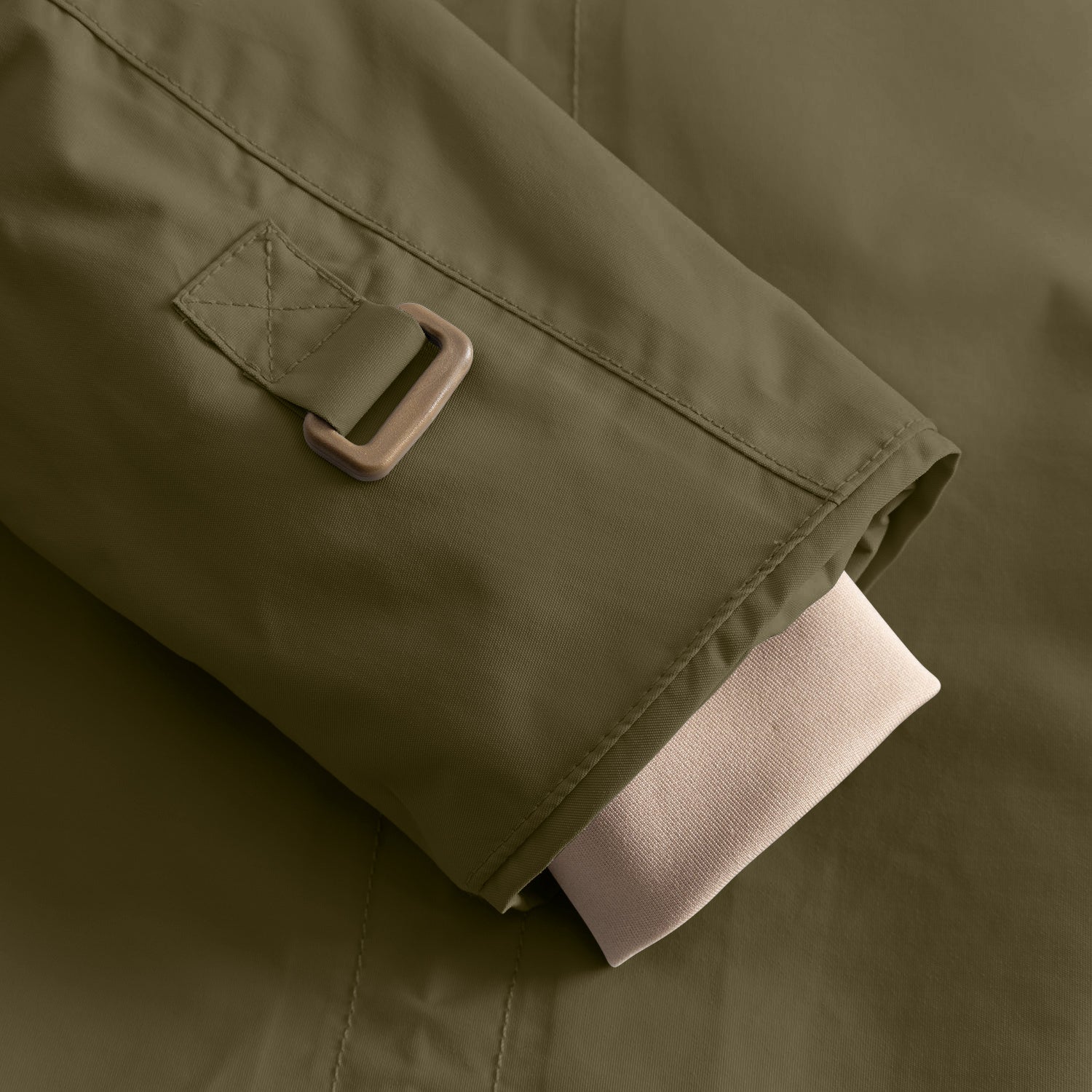 Close-up of the MATWALLY fleece lined winter jacket sleeve showing the adjustable snow cuff with thumb opening and hook-and-loop fastening tab in olive green, with the beige inner cuff visible.