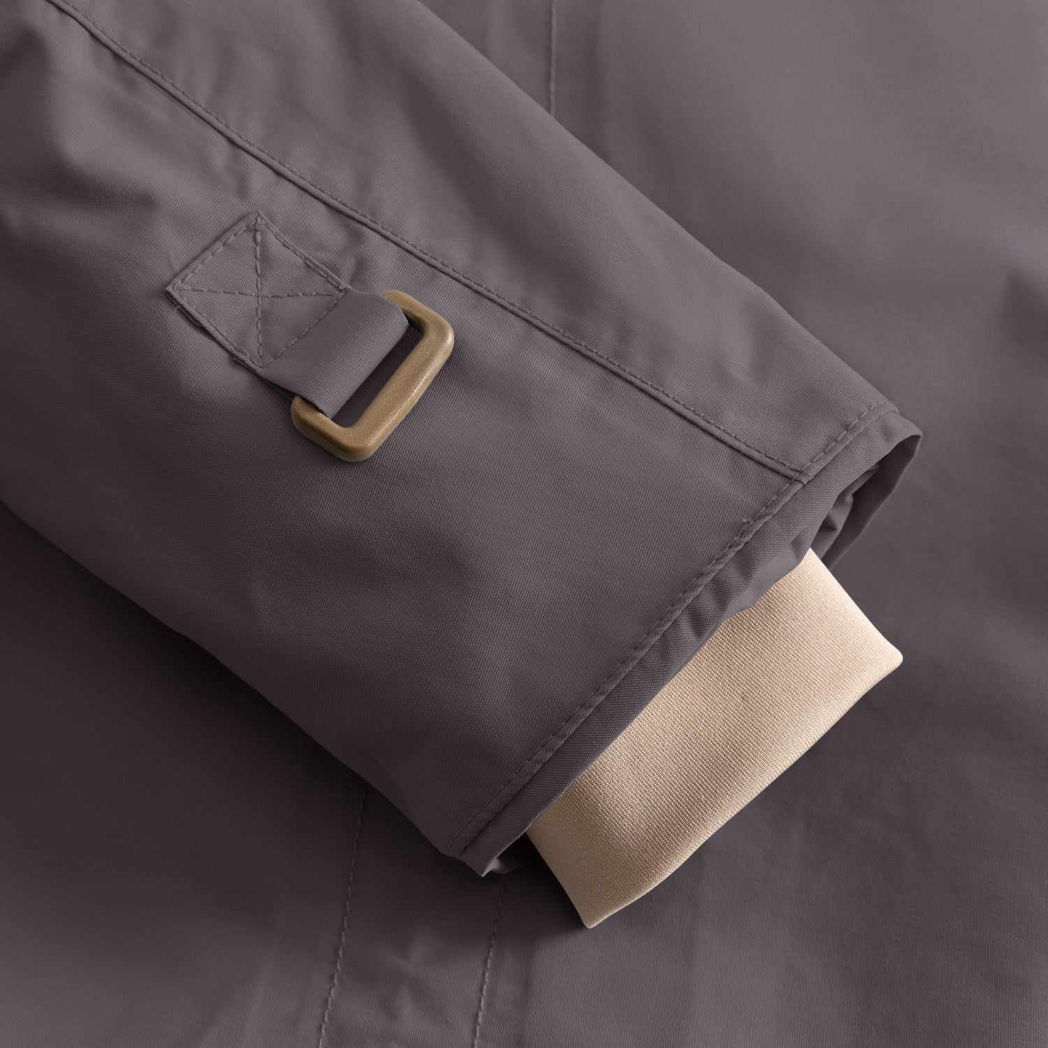 Detail of the MATWALLY fleece lined winter jacket sleeve in charcoal grey, showing the metal D-ring with fabric tab for snow cuff adjustment and the beige ribbed inner cuff with thumb opening visible at the hem.