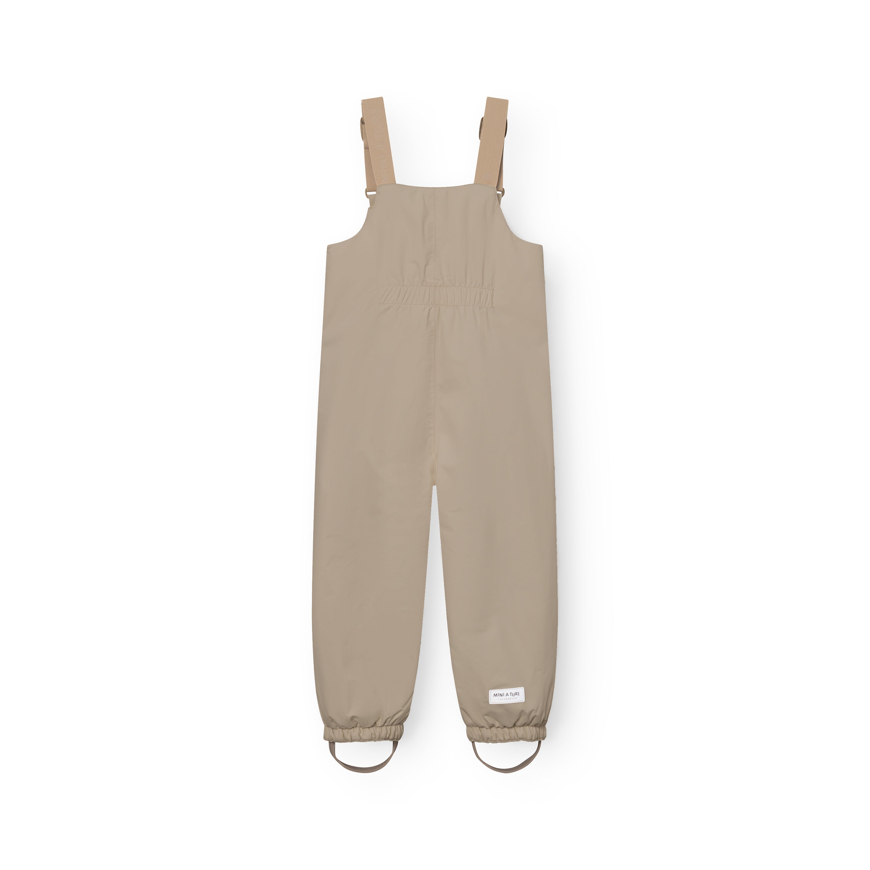 MATWALENTEX snow pants in soft taupe displayed from the front, showing beige adjustable suspenders with metal clips, elasticated waistband, elasticated ankle cuffs with matching taupe foot straps and a white MINI A TURE label at the lower leg on a white background.