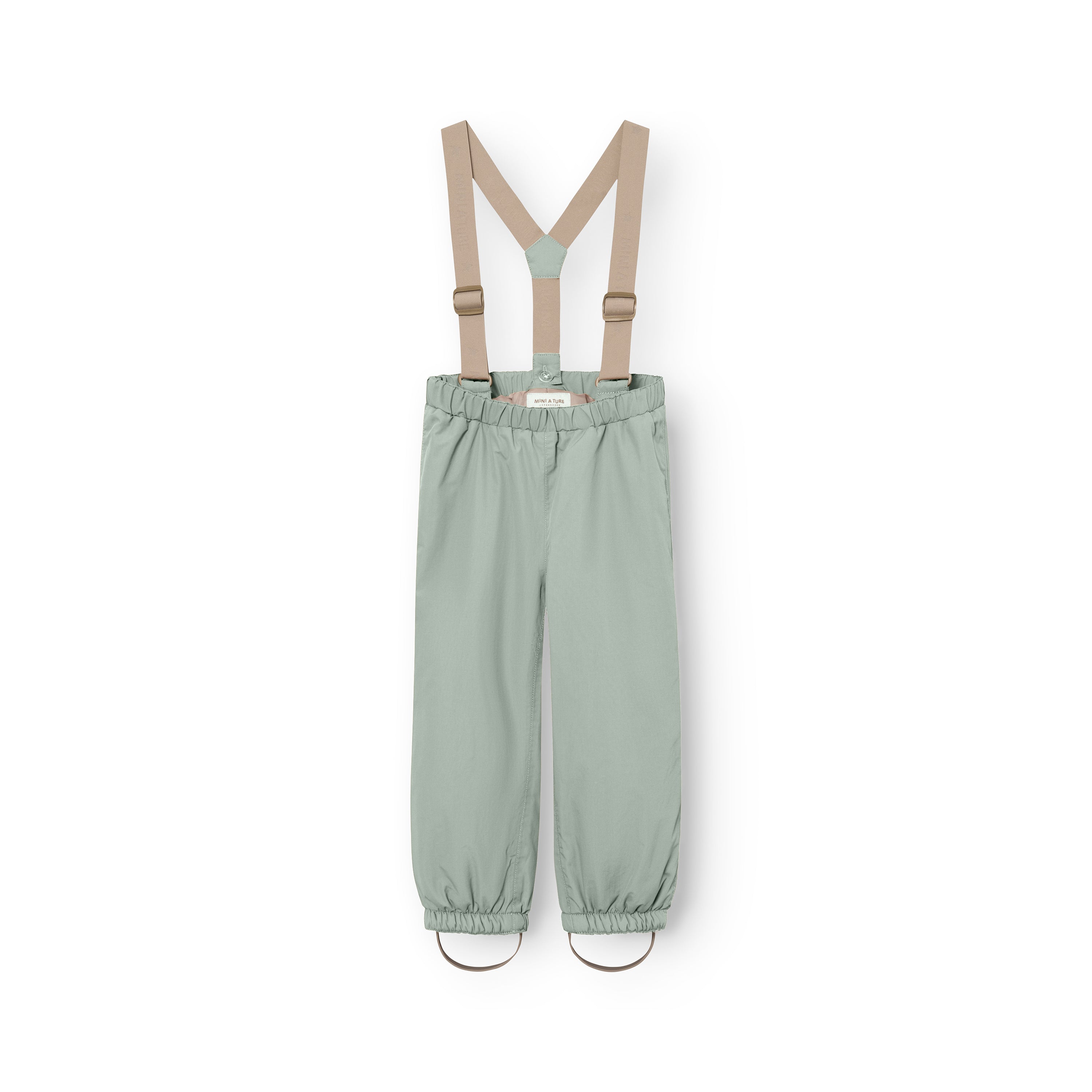 MATWILAS snow pants in soft sage green with detachable beige braces and elasticated ankle cuffs with foot straps, laid flat against a white background.