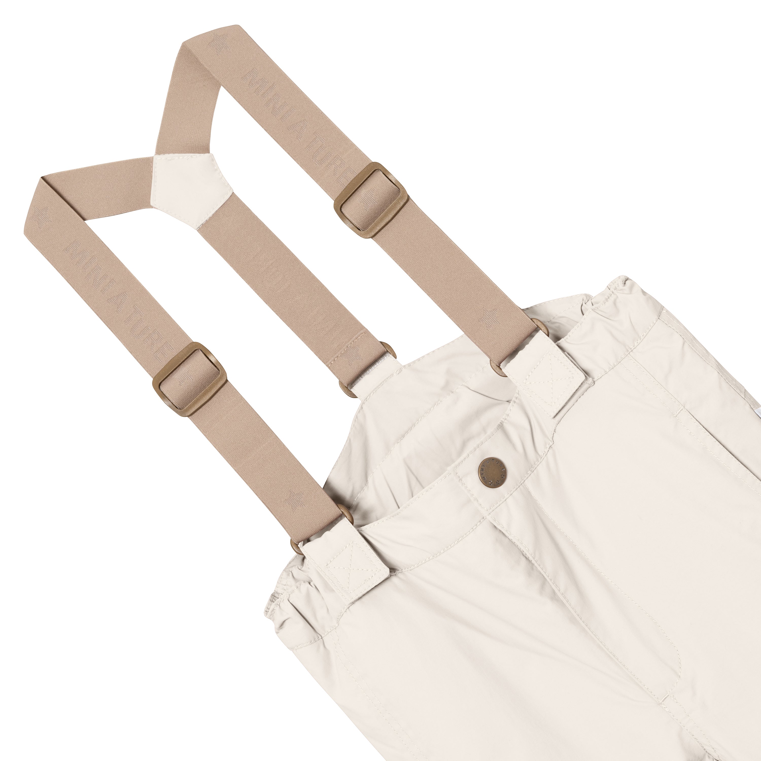 MATWITTE snow pants in cream showing the front waistband detail with snap-button closure, elasticated panel and the removable beige elastic suspenders with metal slider adjusters crossing at the front and attaching through fabric loops.