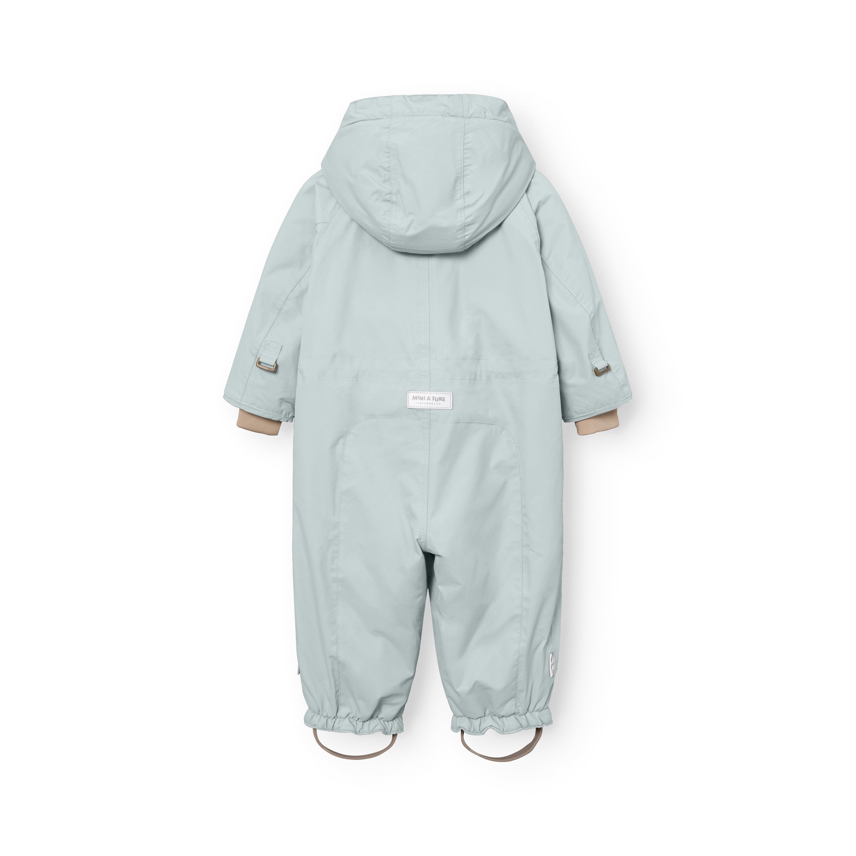 MATWISTI fleece lined snowsuit in pale blue laid flat showing the rear view with detachable hood, white MINI A TURE label at the lower back, beige ribbed cuffs and elasticated leg openings with adjustable foot straps featuring metal D-rings.