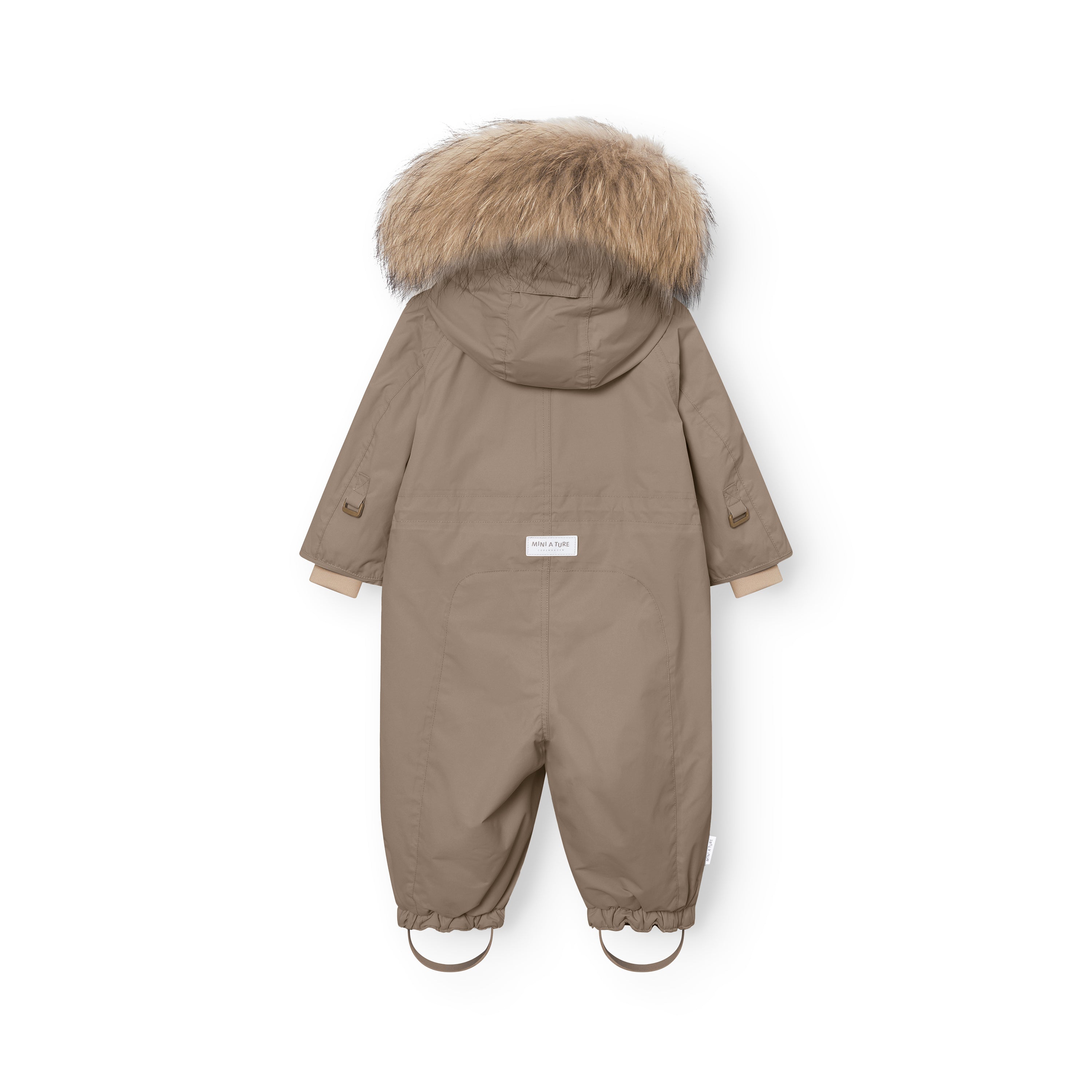 Rear view of MATWISTI fleece lined snowsuit fur showing the taupe waterproof shell, genuine fur-trimmed hood, MINI A TURE label at the back, and adjustable foot straps at the ankles.