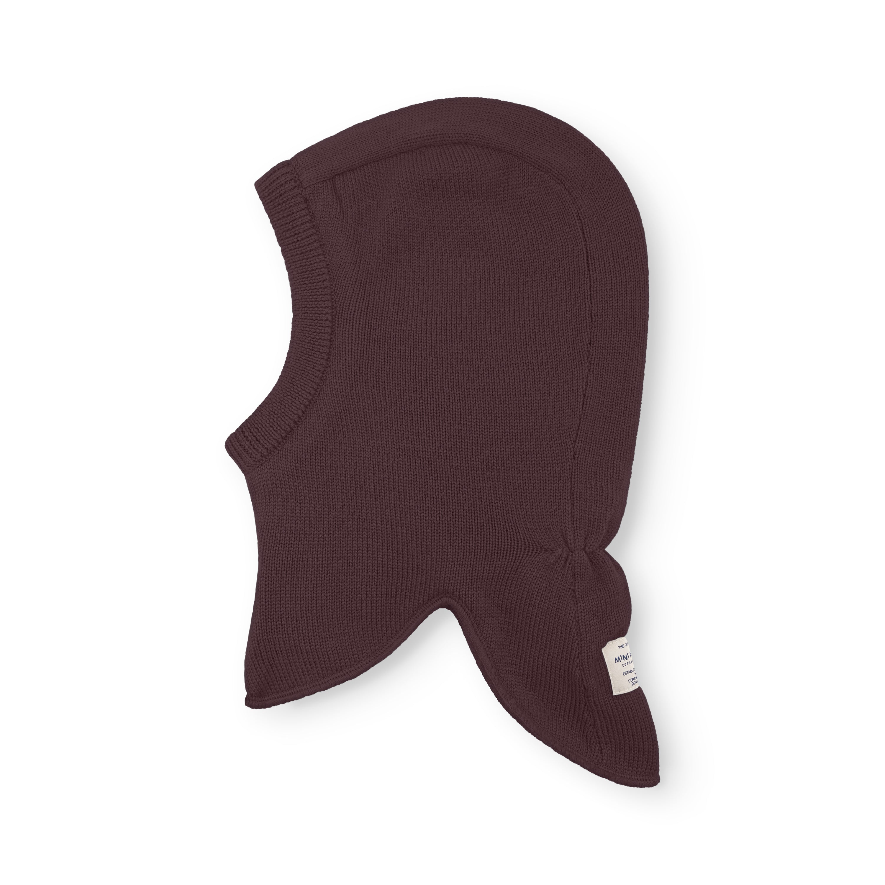MATJORK balaclava in dark plum shown flat, displaying the knitted merino wool outer, extended neck panel and windstoppers at the ear positions, with the MINI A TURE label visible at the lower edge.