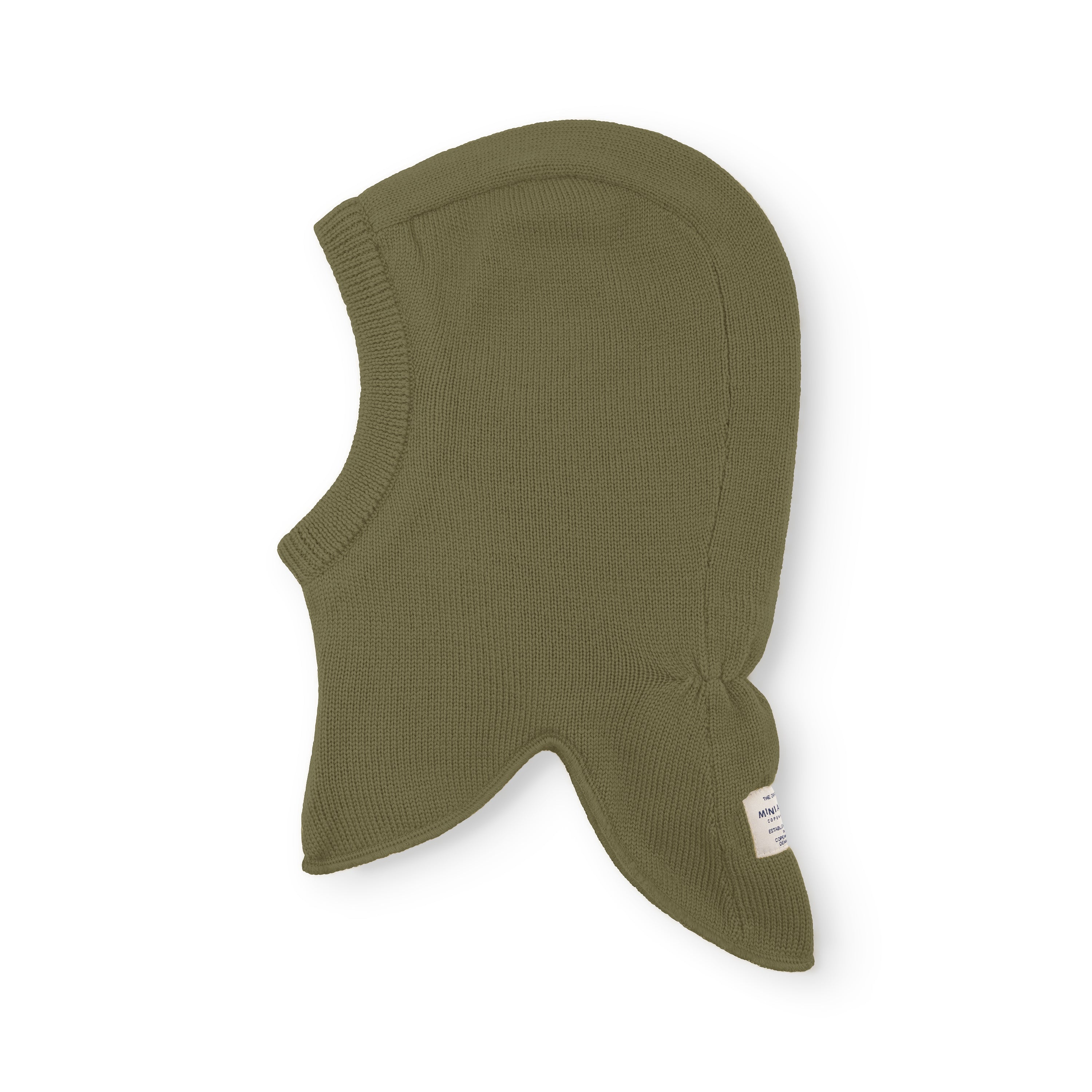 MATJORK balaclava in olive green merino wool shown flat, highlighting the seamless knitted construction, integrated neck panel and windstoppers at the ears, with the MINI A TURE label visible at the lower right edge.