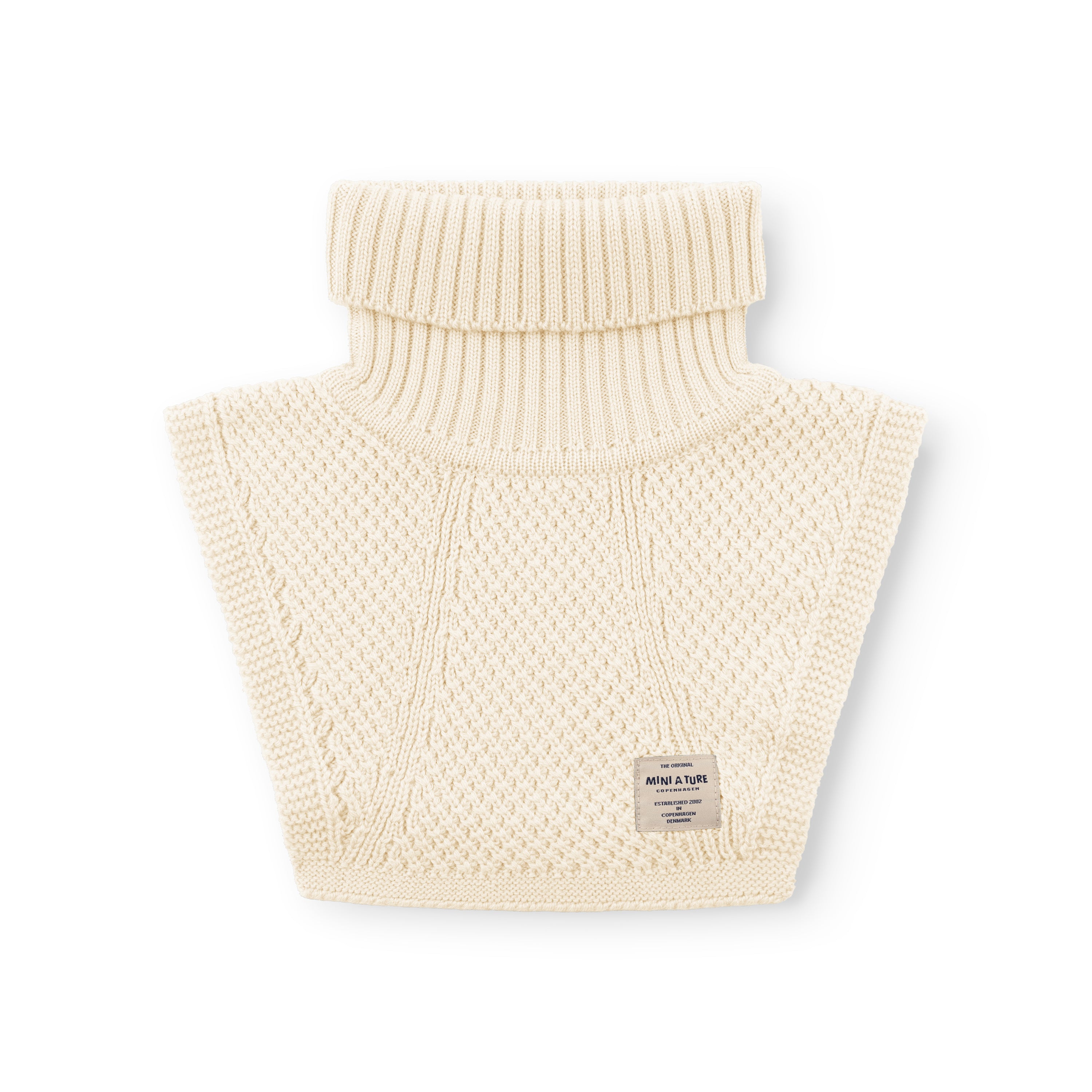 MATTAYLER neckwarmer in cream merino wool, photographed flat against a white background, showing the wide ribbed high neck folded over and moss-stitch textured body panels with a MINI A TURE label at the lower centre.