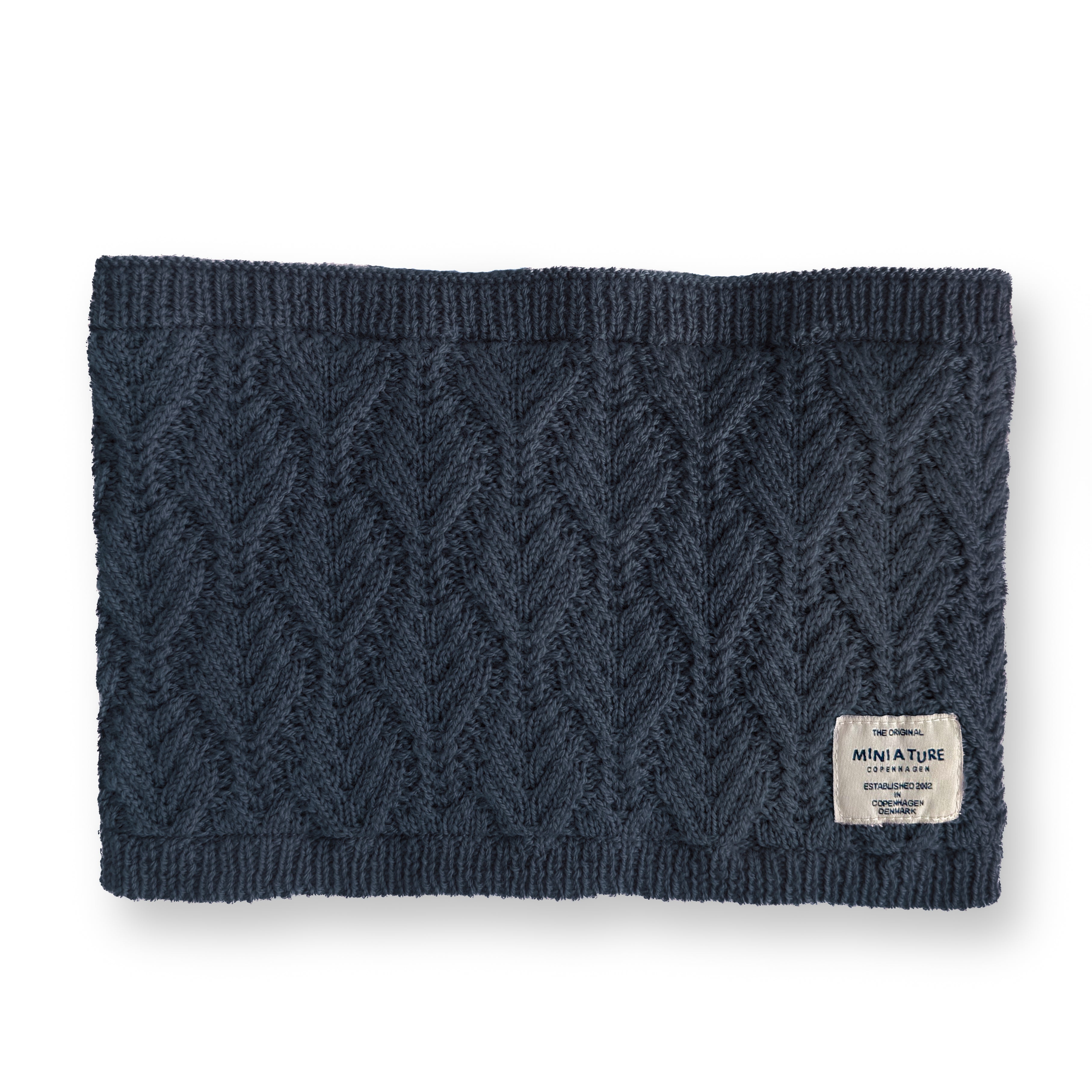 MATGOI fleece lined neckwarmer displayed flat in deep navy merino wool with a chevron knit pattern, ribbed top and bottom edges, and a woven MINI A TURE label at the lower right.