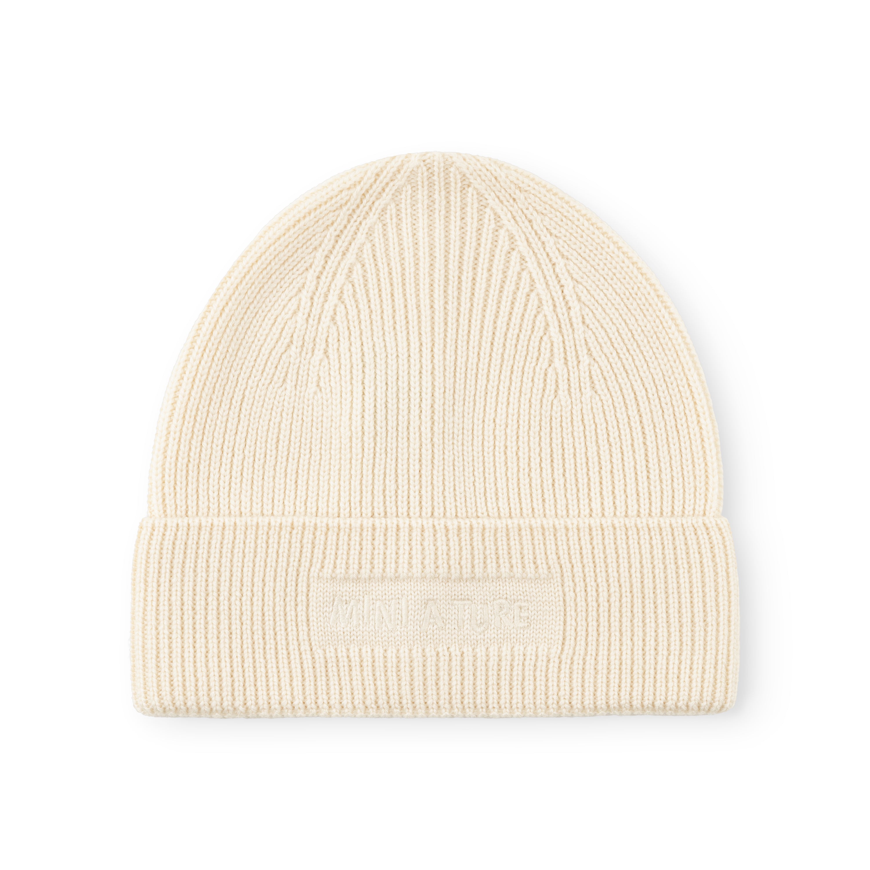 MATBOJE beanie in cream merino wool with a ribbed knit structure and fold-up brim, displayed flat to show the embroidered logo detail.