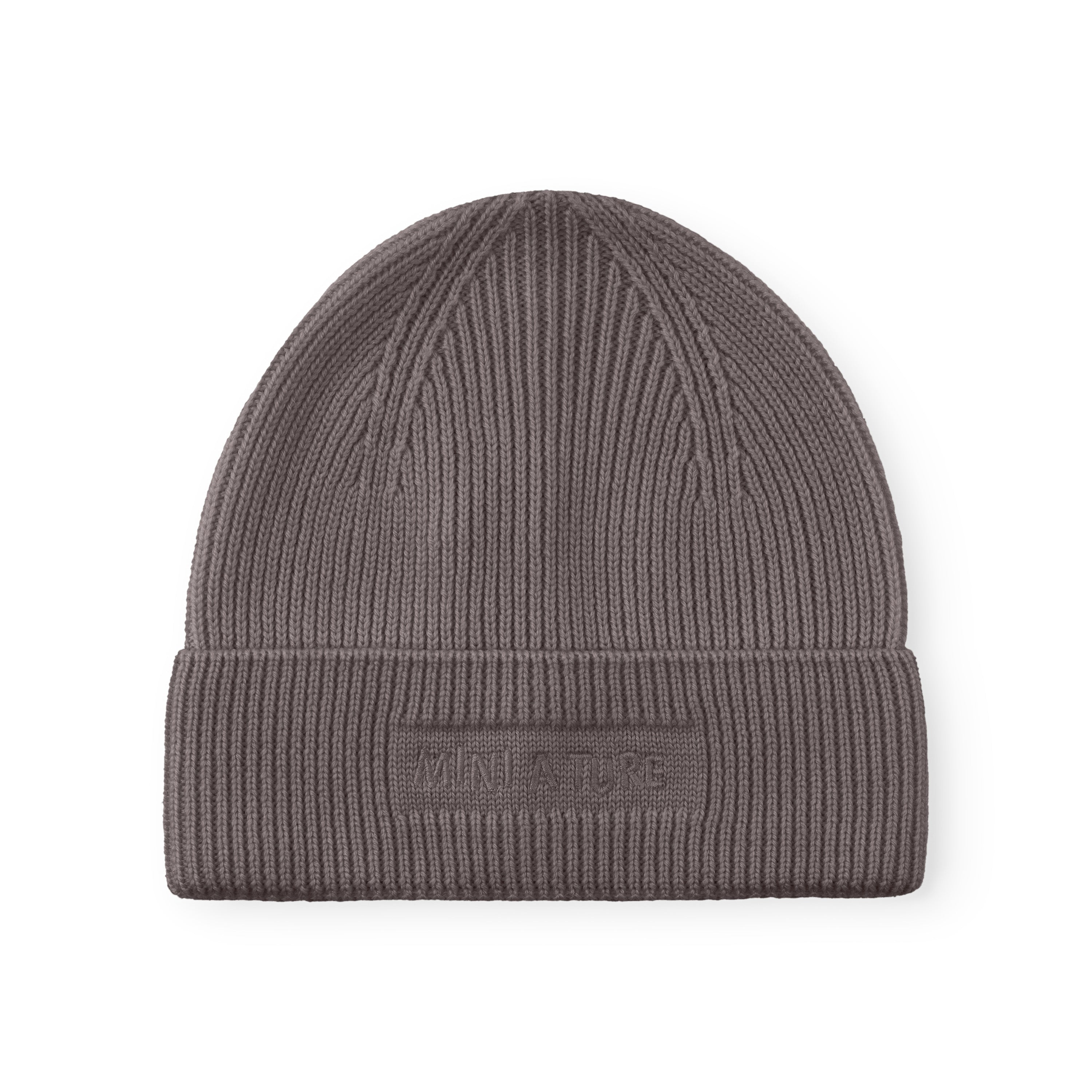 MATBOJE beanie in muted grey merino wool with a ribbed knit and fold-up brim, laid flat against a white background showing the embroidered MINI A TURE logo.