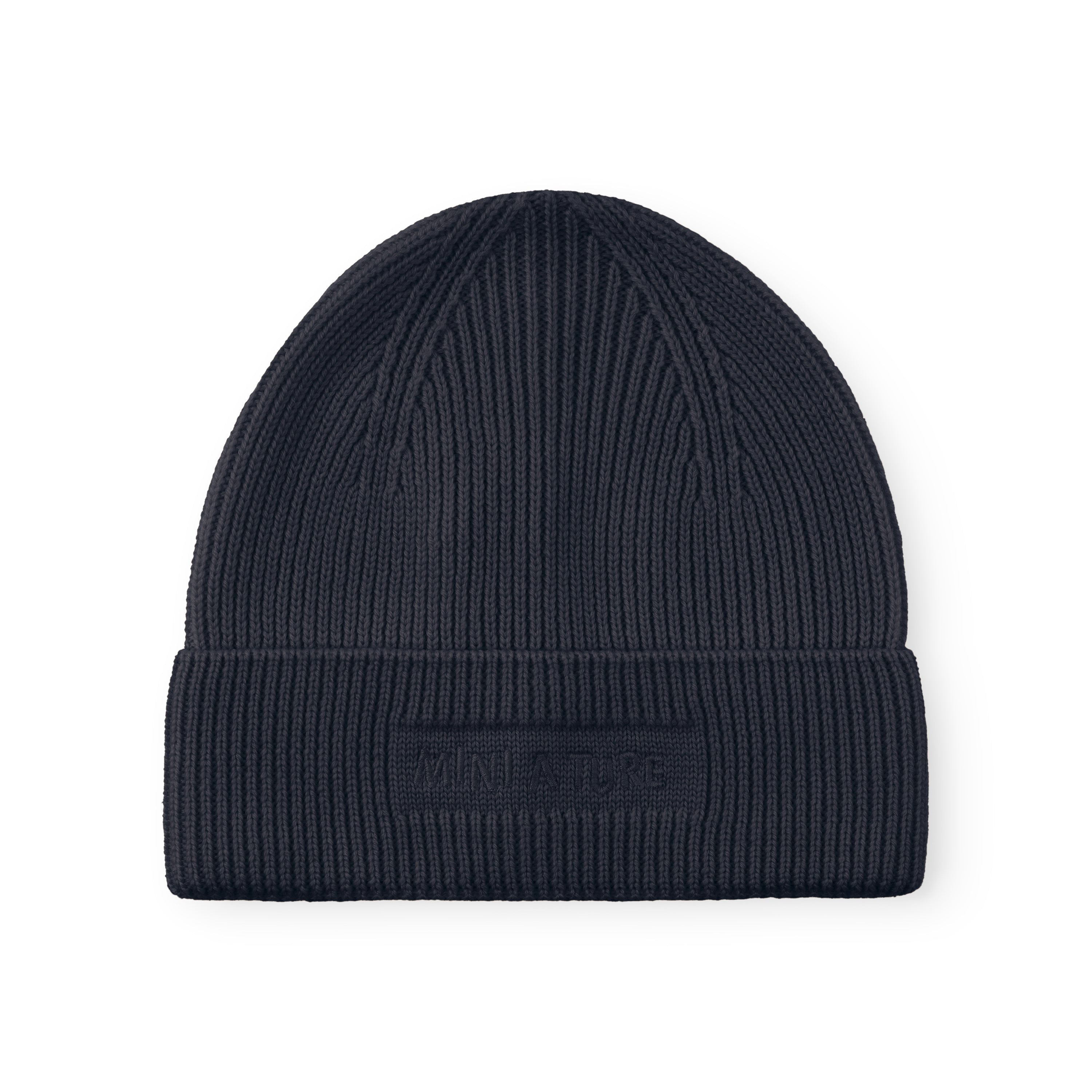 MATBOJE beanie in navy merino wool with a ribbed knit and fold-up brim, laid flat to show the embroidered logo on the front.
