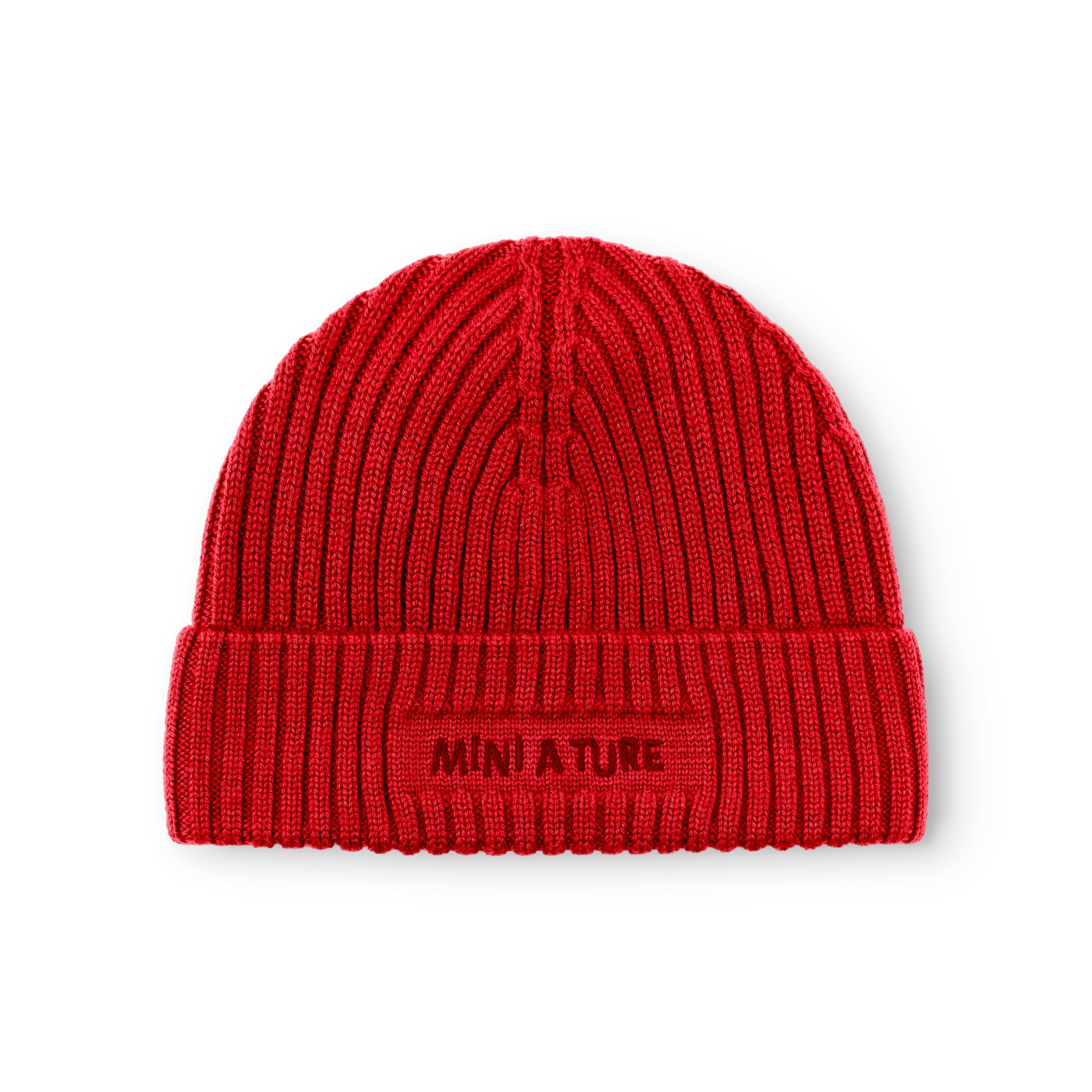 MATBOJE fleece lined beanie in bright red merino wool with the fold-up brim worn in place, highlighting the embroidered MINI A TURE logo and the pronounced ribbed knit pattern across the entire hat.