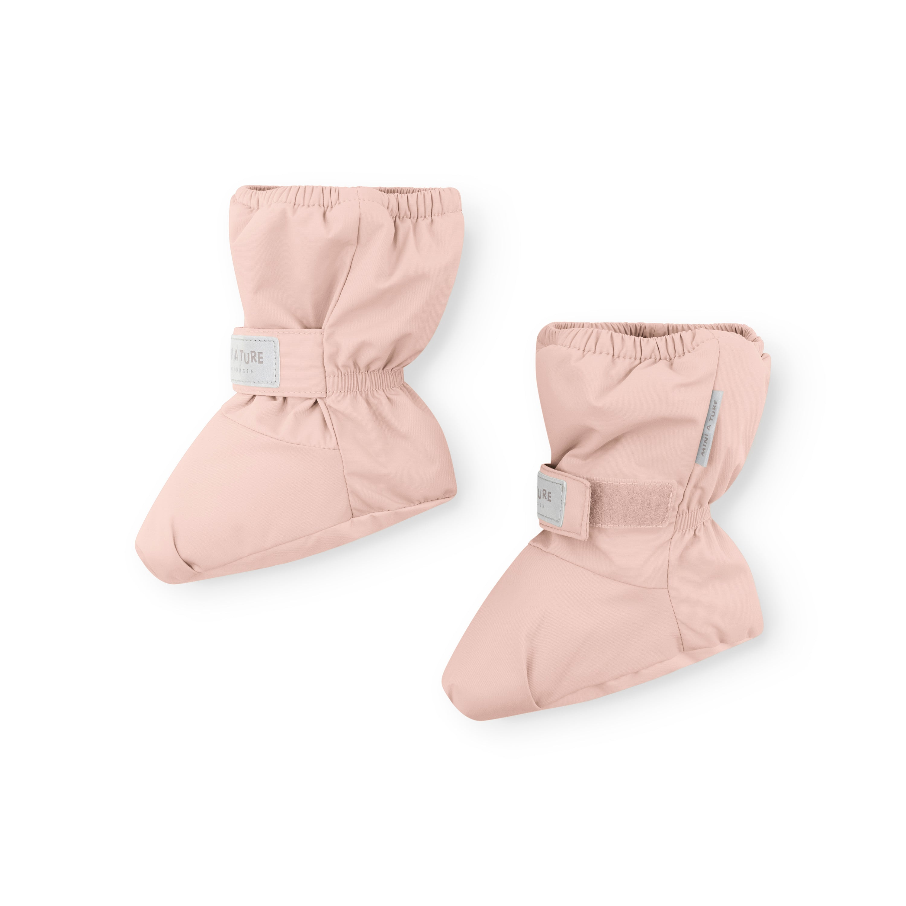 MATWINN fleece lined baby outdoor socks in pale pink with elasticated ankle cuffs and adjustable velcro closure, photographed from above to show the padded foot shape and windproof recycled polyamide construction.