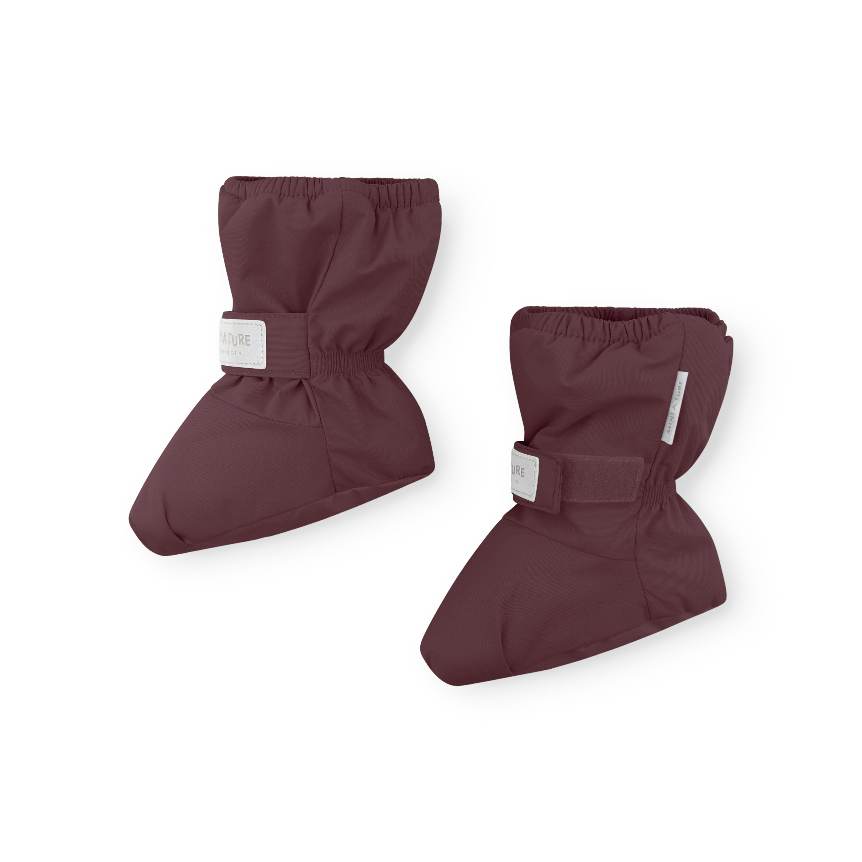 MATWINN waterproof baby outdoor socks in deep burgundy with adjustable velcro ankle strap and elasticated cuff, photographed as a pair to show the insulated foot shape and reflective detail for visibility during cold-weather pram outings.