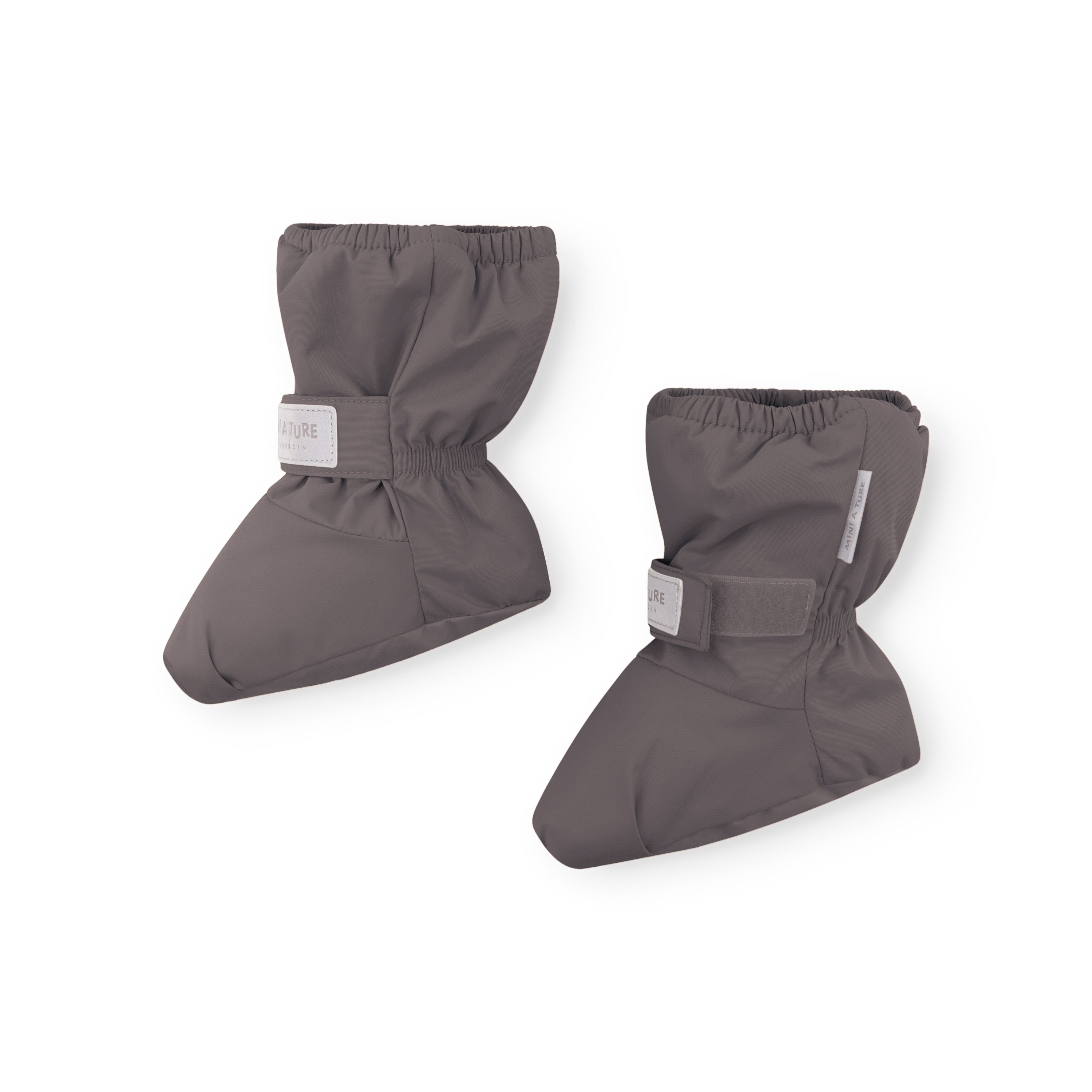 MATWINN waterproof baby outdoor socks in charcoal grey with velcro ankle strap and elasticated cuff, photographed as a pair at an angle to show the three-dimensional padded shape and windproof recycled polyamide shell for non-walking infants.
