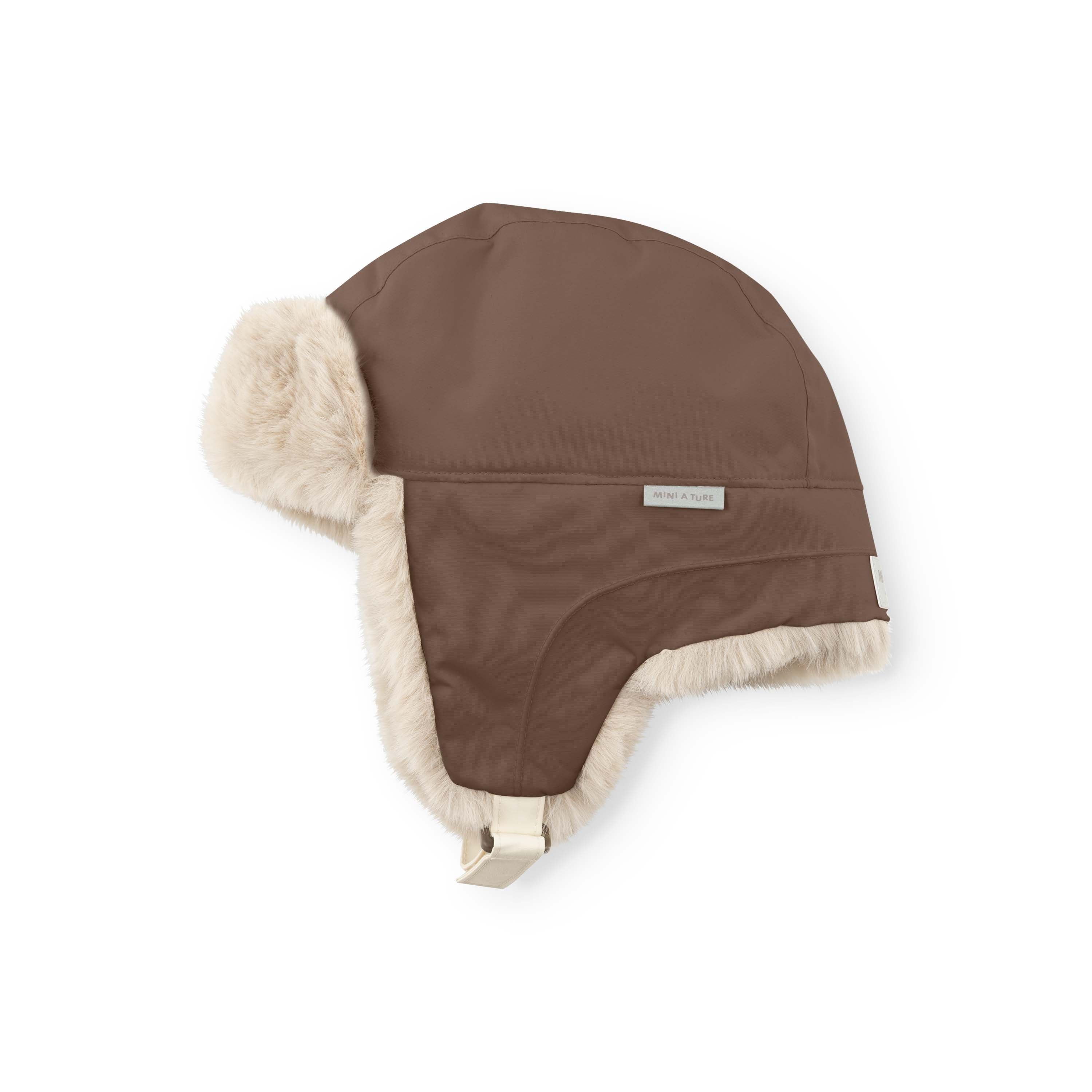 MATCRISTER waterproof trapper hat in warm brown with cream fleece ear flaps and lining, shown from a side angle with the chin strap fastening visible against a white background.