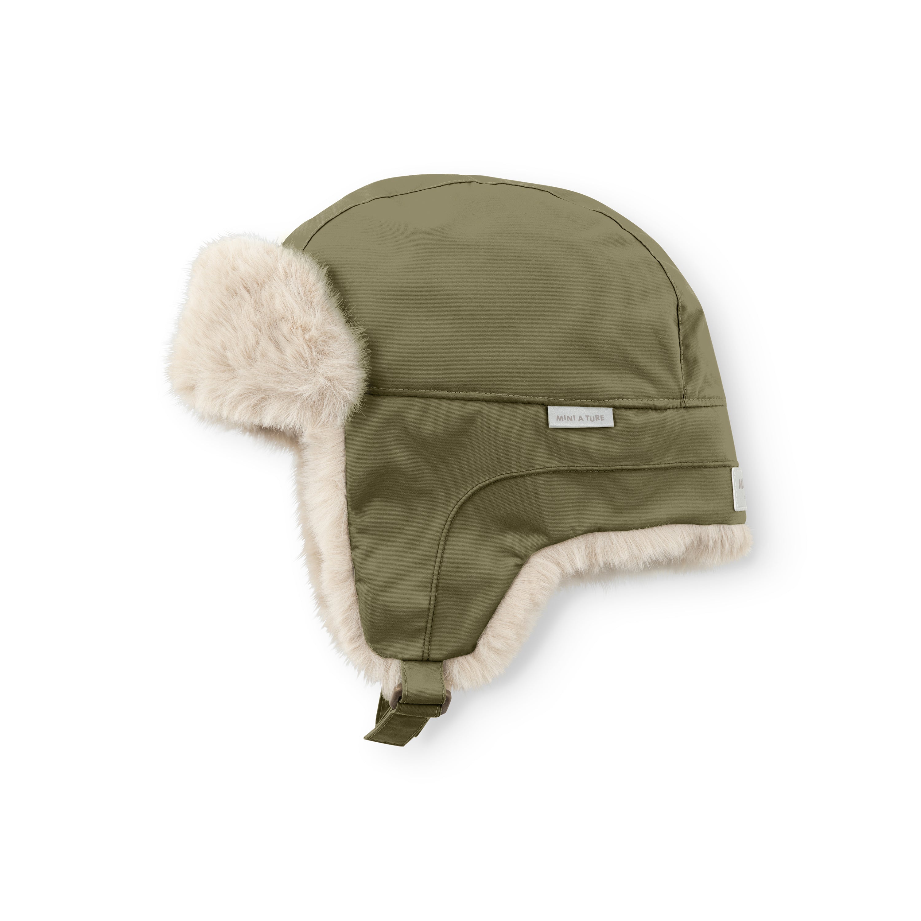 MATCRISTER waterproof trapper hat in olive green with pale beige fleece lining, photographed at an angle on a white background showing the taped seams, woven MINI A TURE label and velcro chin strap with one ear flap extended.