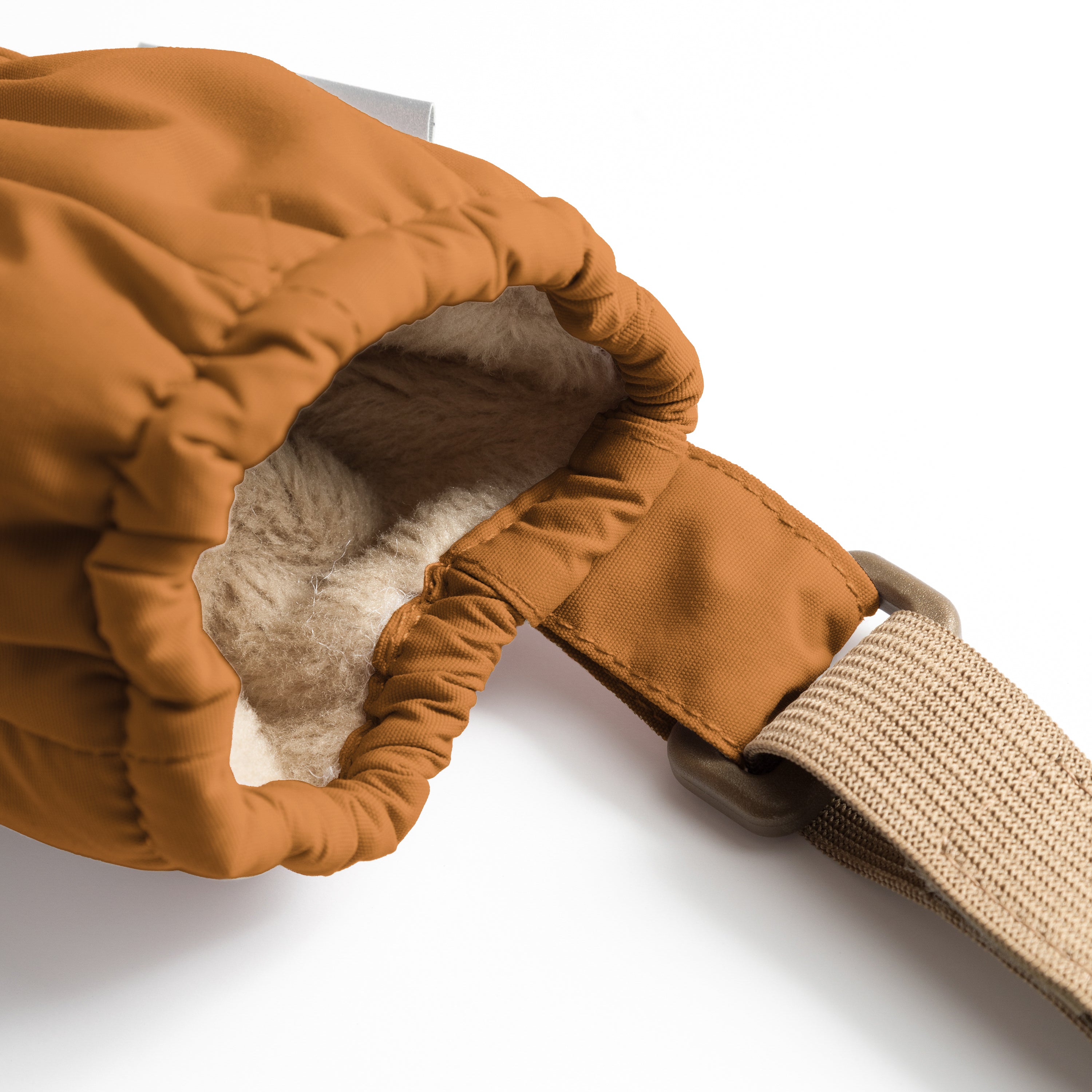 MATCORDT fleece lined mittens in caramel brown shown from the interior with the cuff folded back, revealing the soft beige fleece lining, THINSULATE padding layer and the elastic gathered construction that seals out cold air at the wrist.