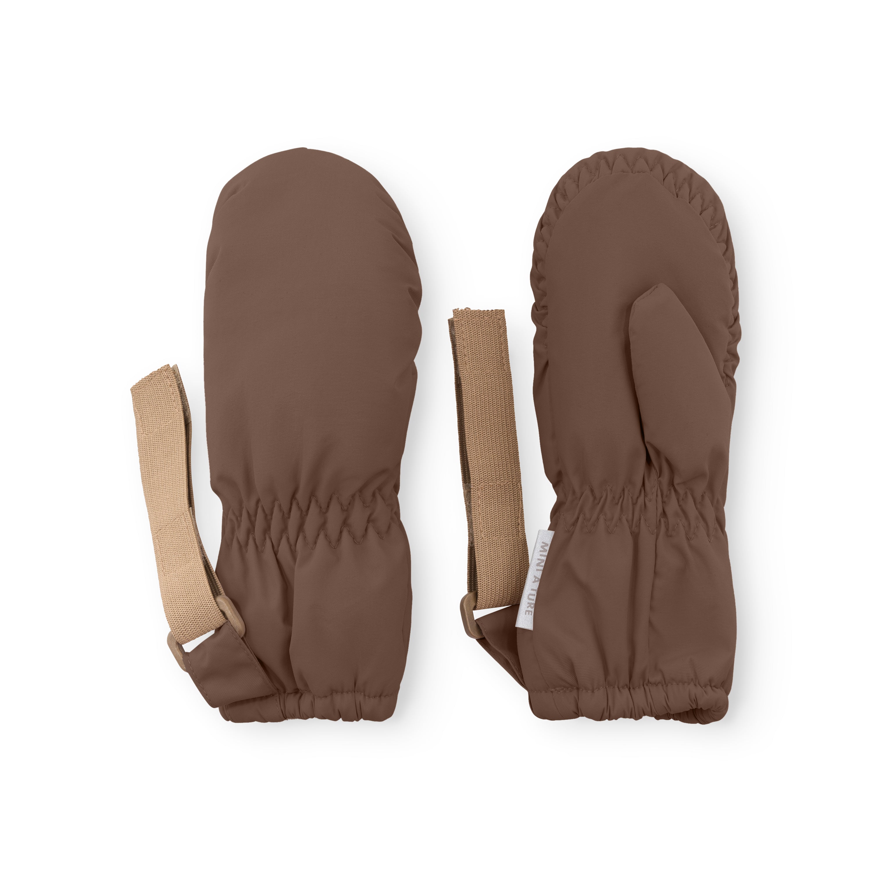 MATCORDT fleece lined mittens in warm brown displayed flat on a white background, showing both the smooth waterproof outer shell and the palm side with elastic gathered cuffs, alongside the extended beige velcro attachment straps and a visible MINI A TURE care label.