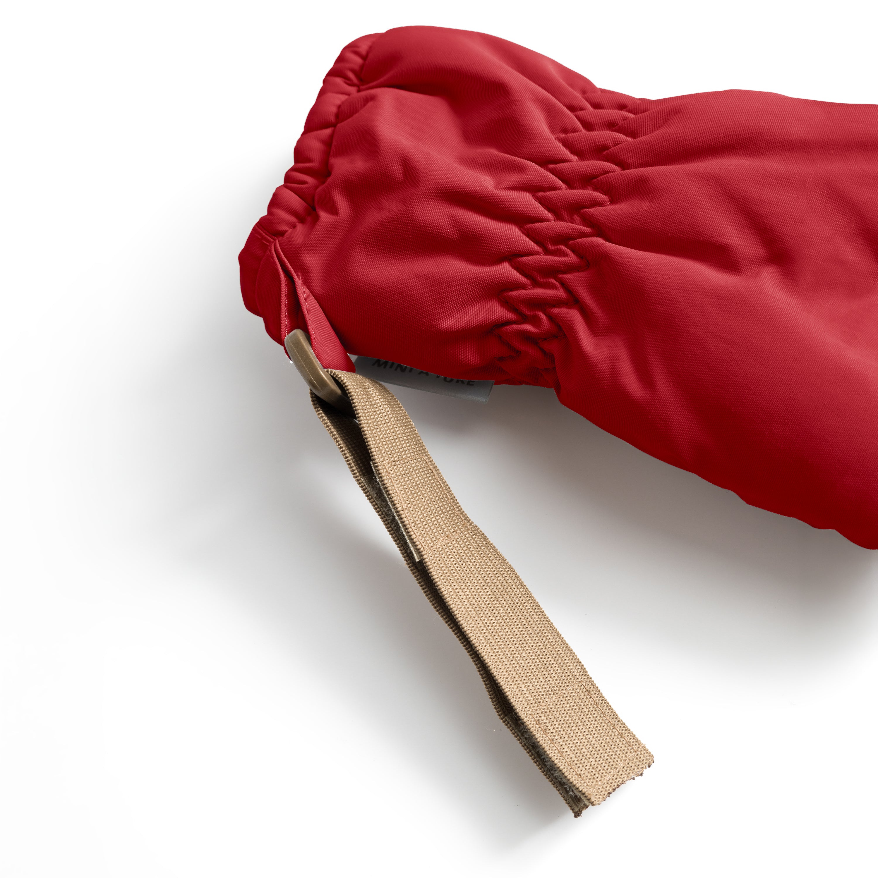 MATCORDT fleece lined mittens in red shown from the cuff opening, highlighting the soft fleece lining, elastic gathered wrist and the beige velcro attachment strap used to secure the mittens to MINI A TURE jackets.