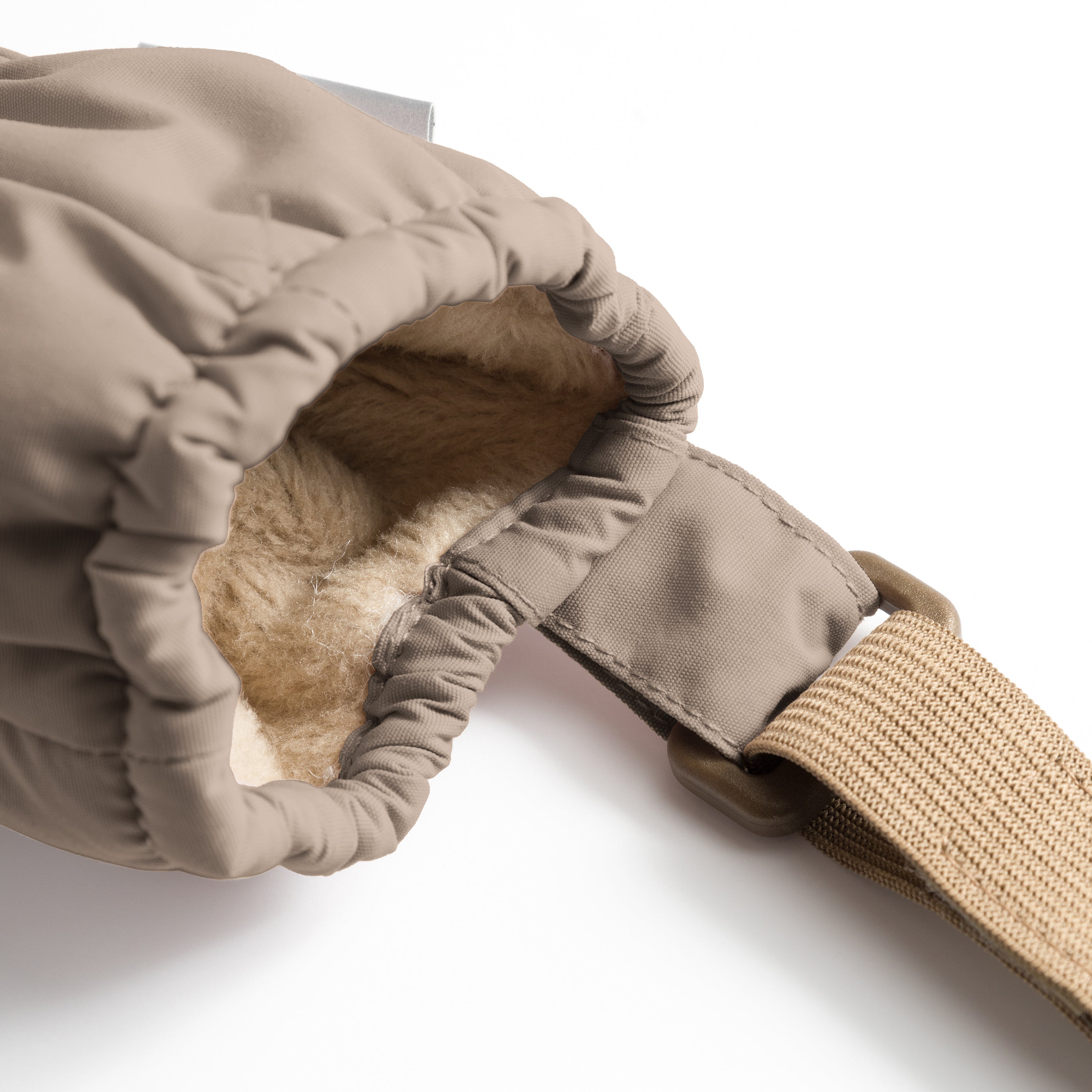MATCORDT fleece lined mittens in warm brown shown partially turned to reveal the contrast between the waterproof recycled polyamide outer shell and the soft beige fleece lining, with elastic gathered cuffs visible at both wrist and top openings and the beige velcro attachment strap extending from the side.
