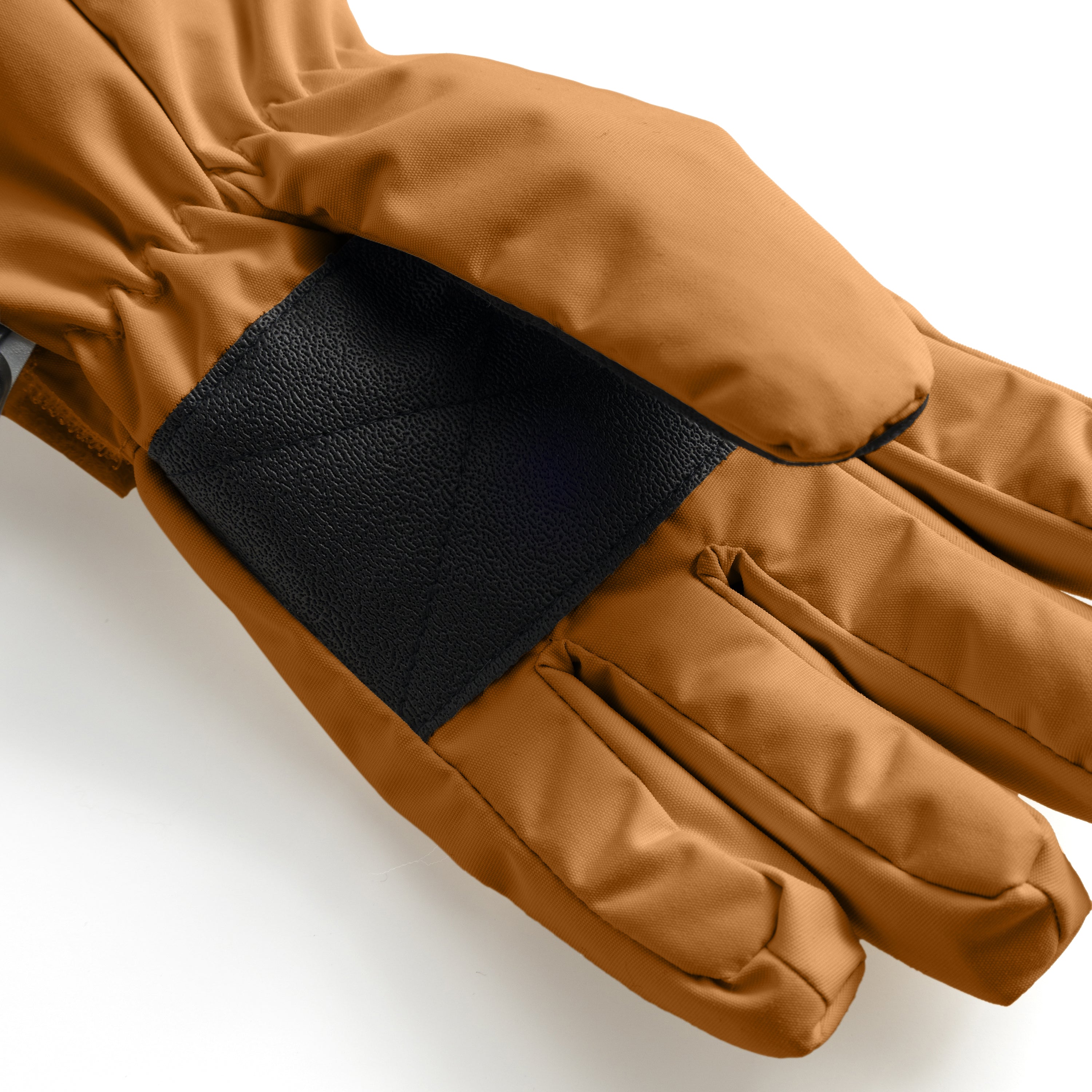 MATCELIO gloves in caramel brown photographed in close-up to show the internal black elasticated wrist cuff and the waterproof recycled nylon outer shell, highlighting the dual-cuff construction that prevents snow and draughts from entering.
