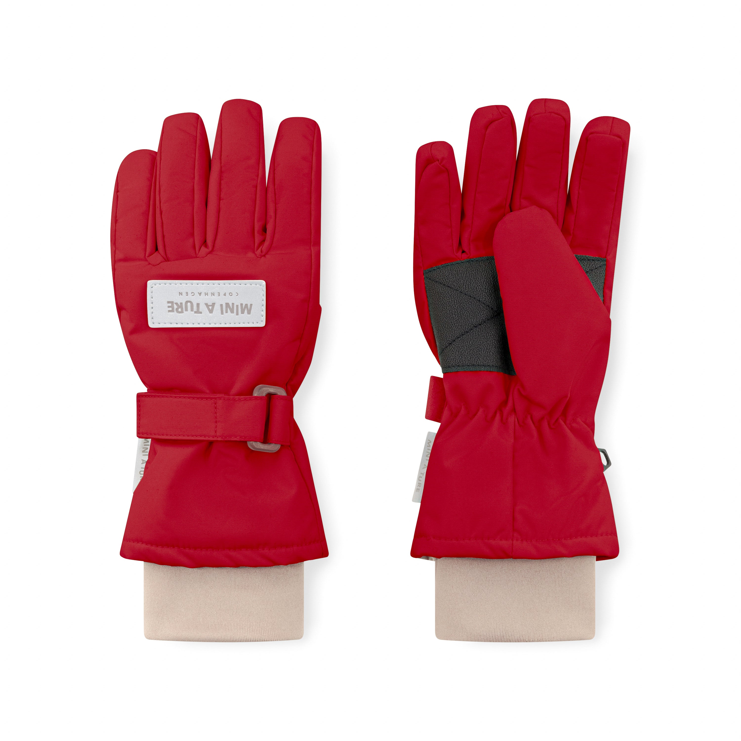 MATCELIO gloves in red displaying palm and back views, with MINI A TURE Copenhagen label on the back of hand, black internal elasticated wrist cuff visible, and adjustable buckle strap on the extended cuff.