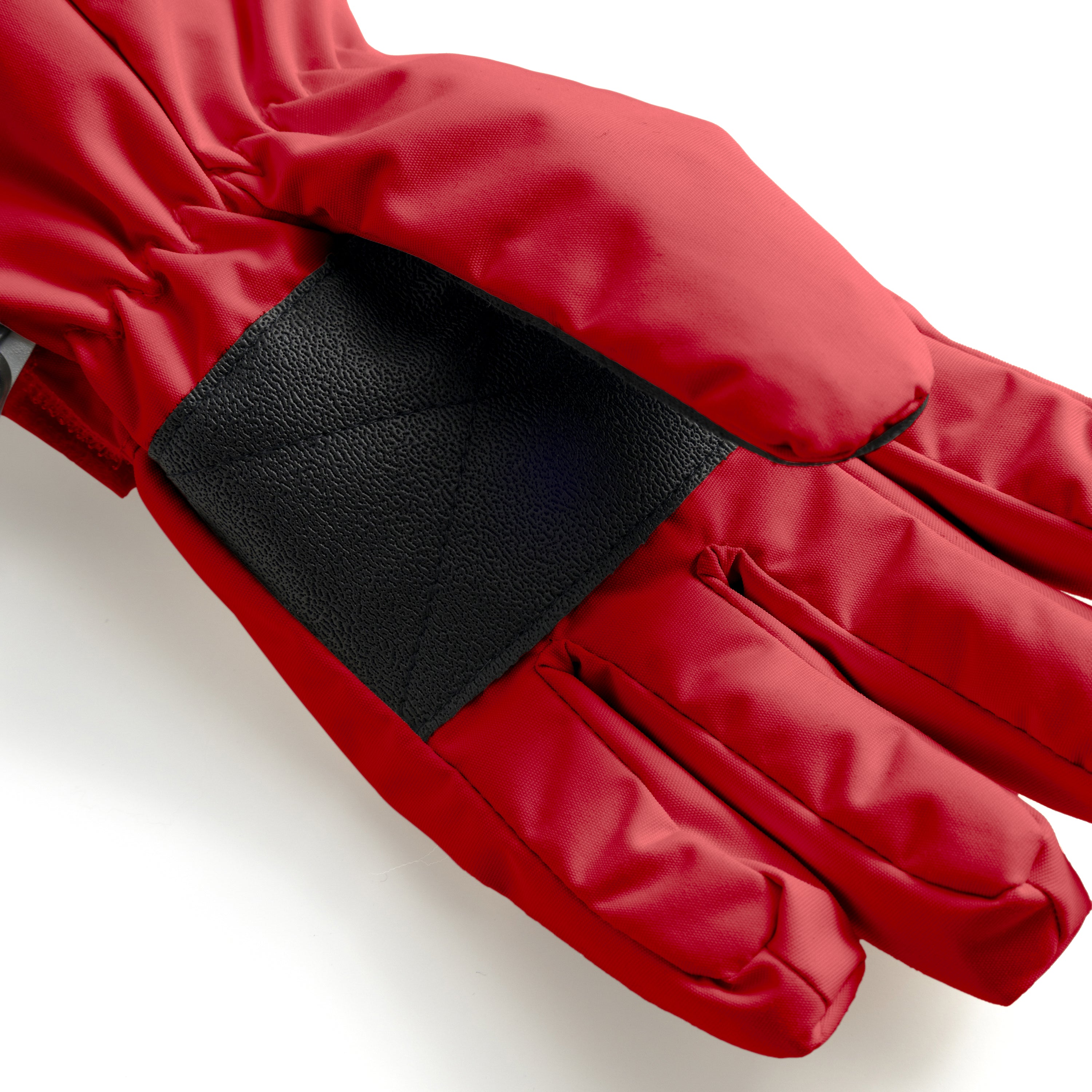 MATCELIO gloves in red photographed in close-up to show the black elasticated wrist cuff positioned inside the extended red cuff, demonstrating the dual-layer construction that seals out cold air and snow during winter wear.