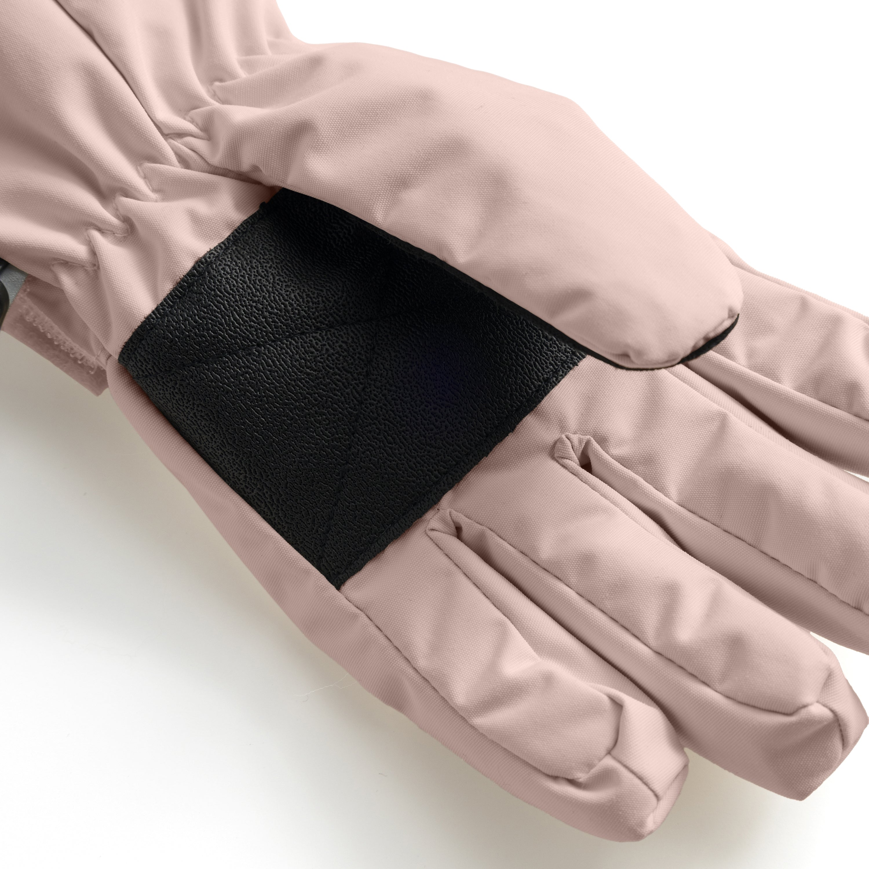MATCELIO gloves in soft pink displaying the internal elasticated wrist cuff in black, photographed in close-up to show the dual-cuff construction that seals out draughts and snow.
