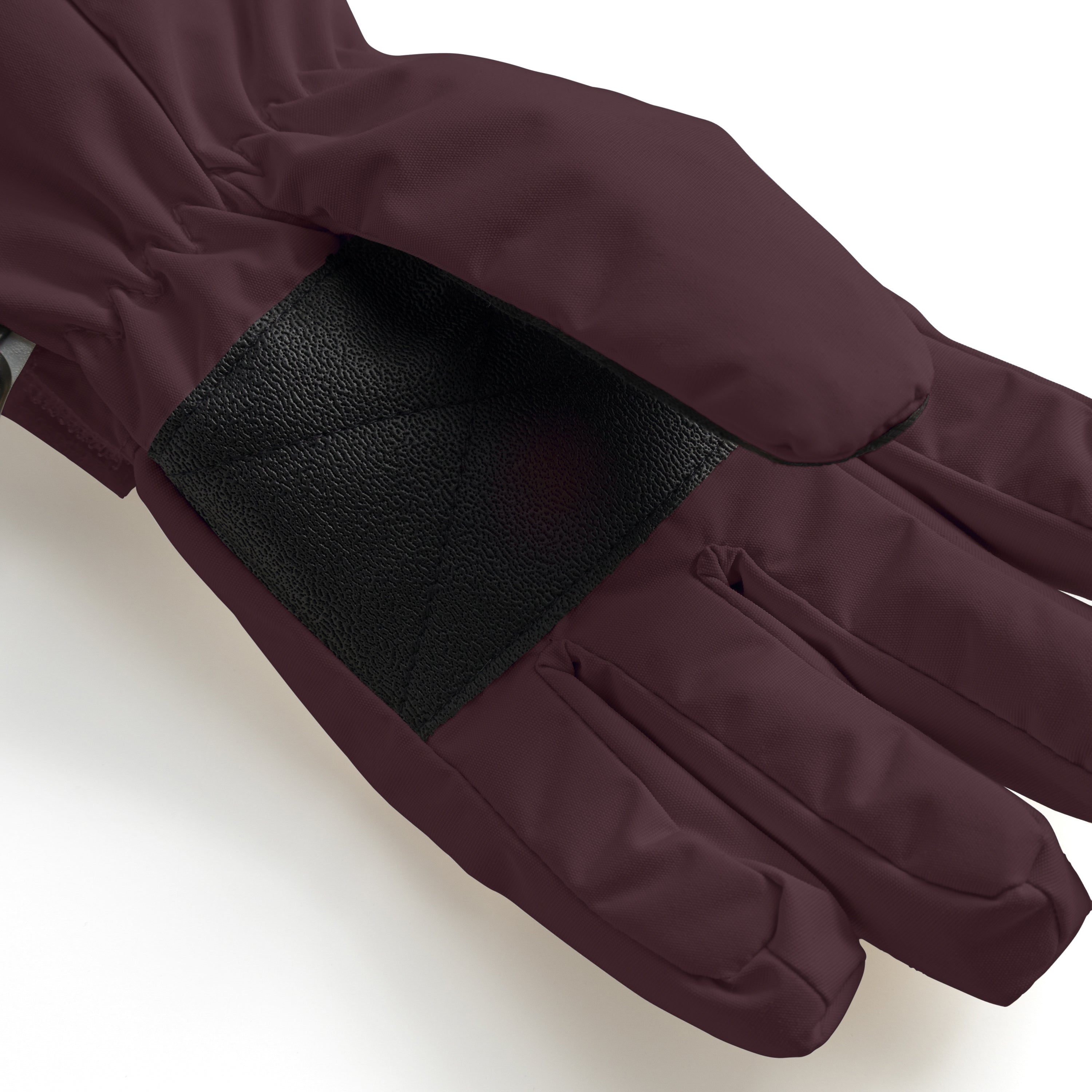 MATCELIO gloves in deep burgundy photographed in close-up to show the black elasticated wrist cuff positioned inside the extended burgundy cuff, demonstrating the dual-layer construction that seals out cold air and snow during winter wear.
