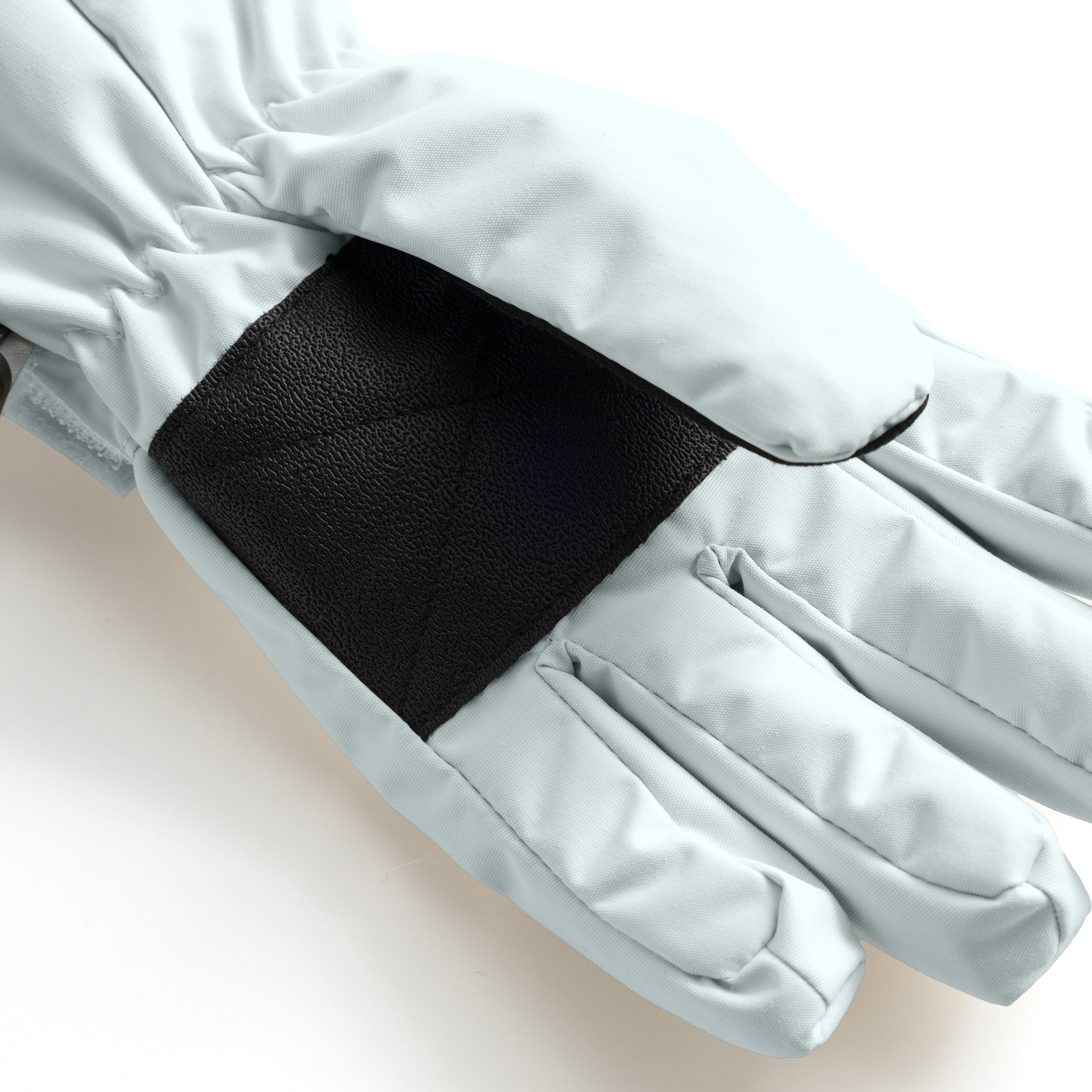 MATCELIO gloves in pale blue-grey photographed in close-up to show the black elasticated wrist cuff positioned inside the extended pale blue-grey cuff, demonstrating the dual-layer construction that seals out cold air and snow during winter wear.