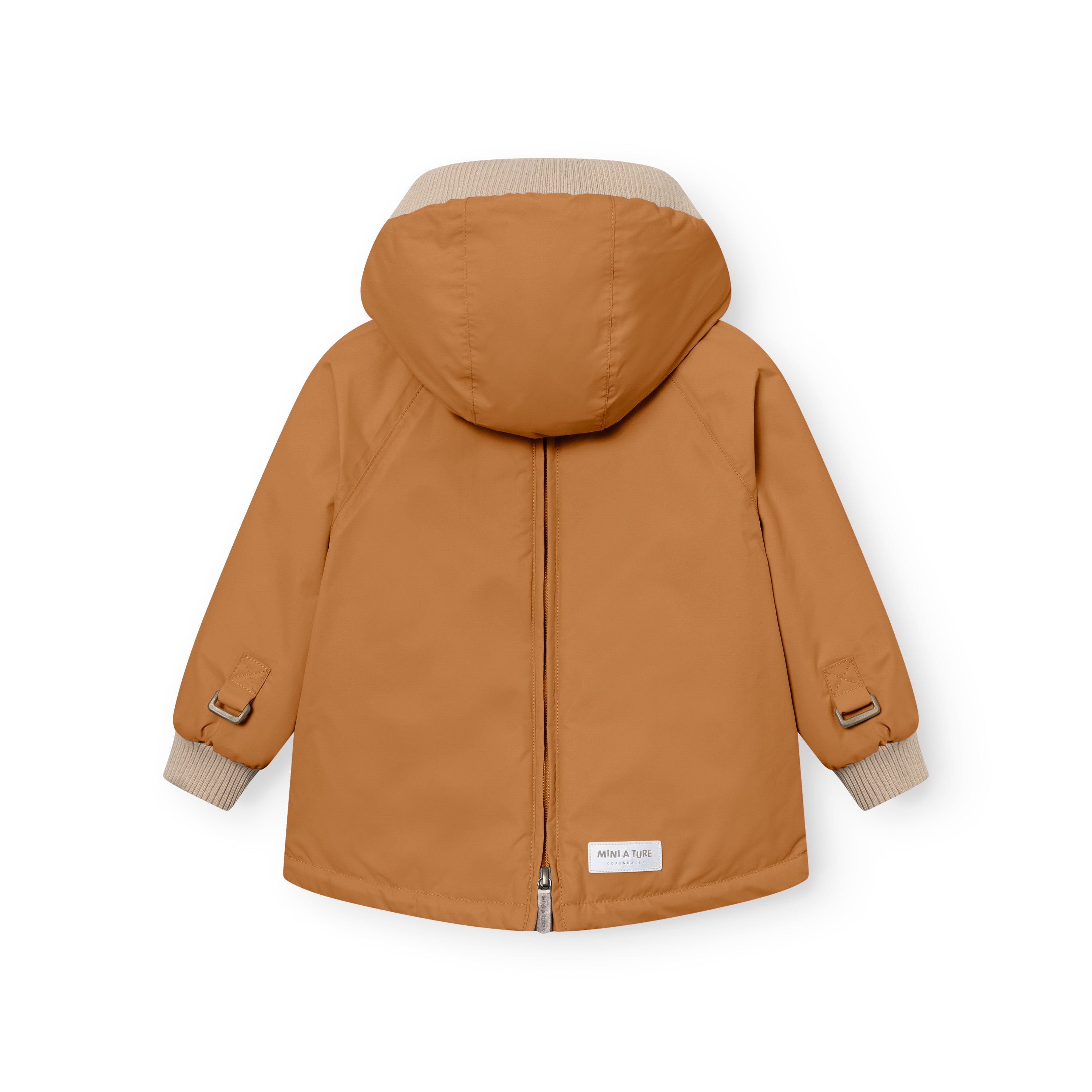 MATBABYWEN anorak in warm caramel brown viewed from the back with the full-length zip closed, showing the beige ribbed hood and cuffs, raglan sleeves with adjustable elasticated tabs secured by metal buckles at each wrist, and a white MINI A TURE label at the lower hem above the central back vent.