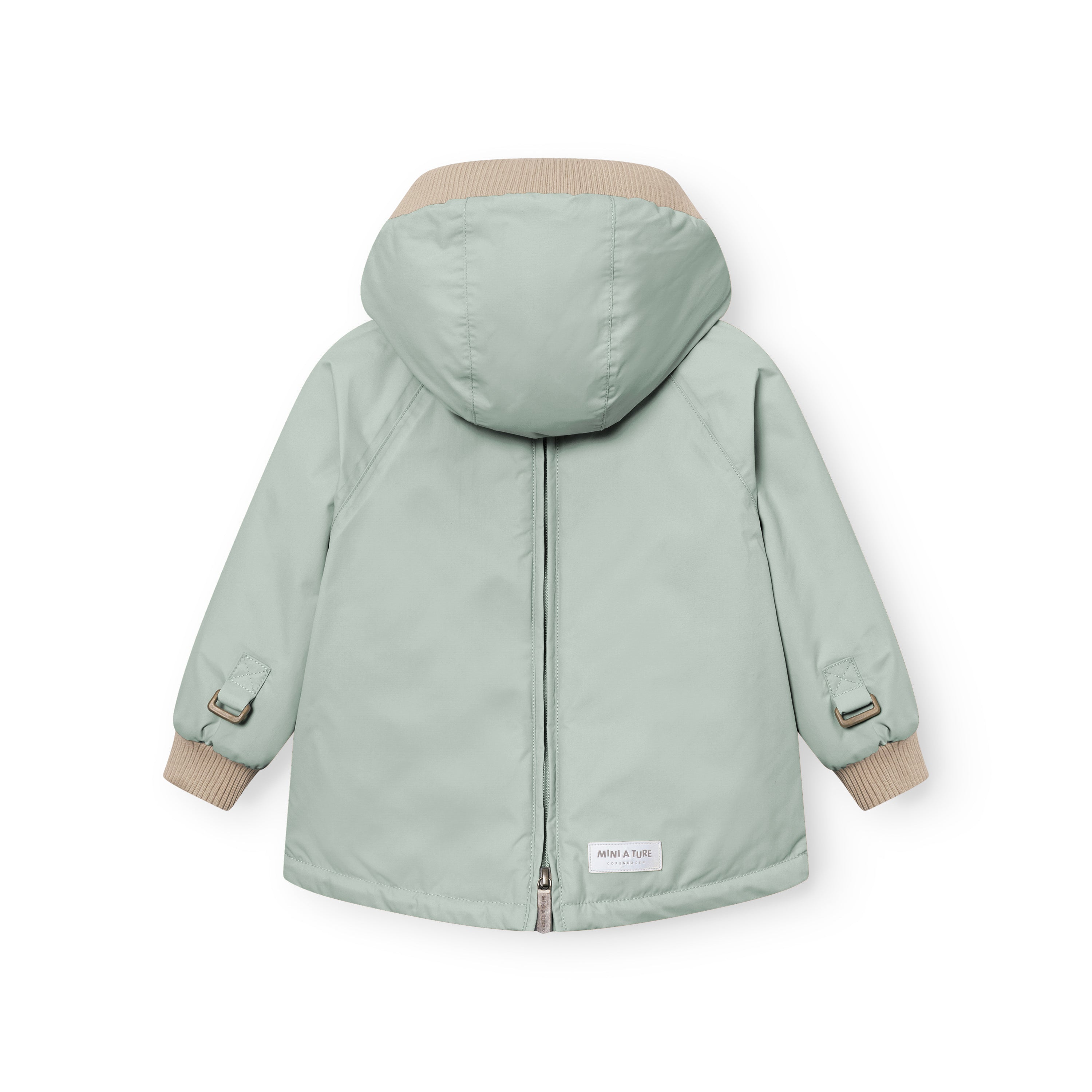 MATBABYWEN anorak in pale green shown from the back with the full-length zip fully closed, displaying the beige ribbed hood and cuffs, raglan sleeves with adjustable tabs at the wrists, and a white MINI A TURE label at the lower back hem.