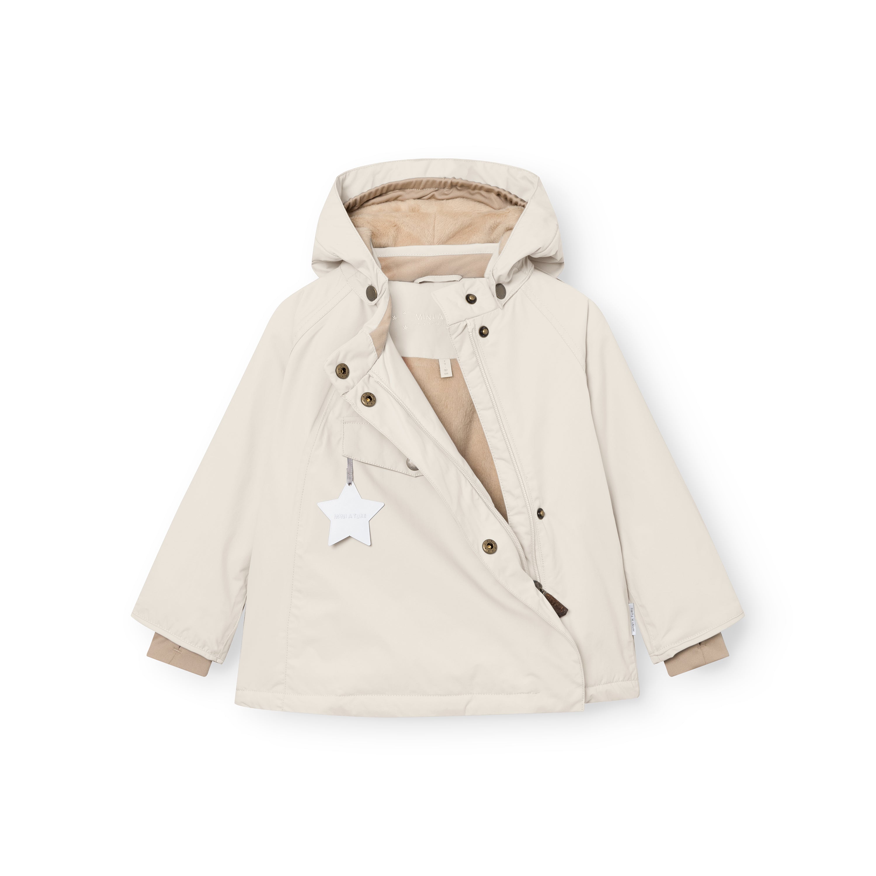 MATWANG fleece-lined winter jacket in soft cream displayed flat with the concealed slanted zip partially open, revealing the beige fleece lining inside, bronze press-stud fastenings along the placket, detachable pointed hood, white reflective star hanging from the chest pocket, and bronze D-ring buckles at the cuffs.