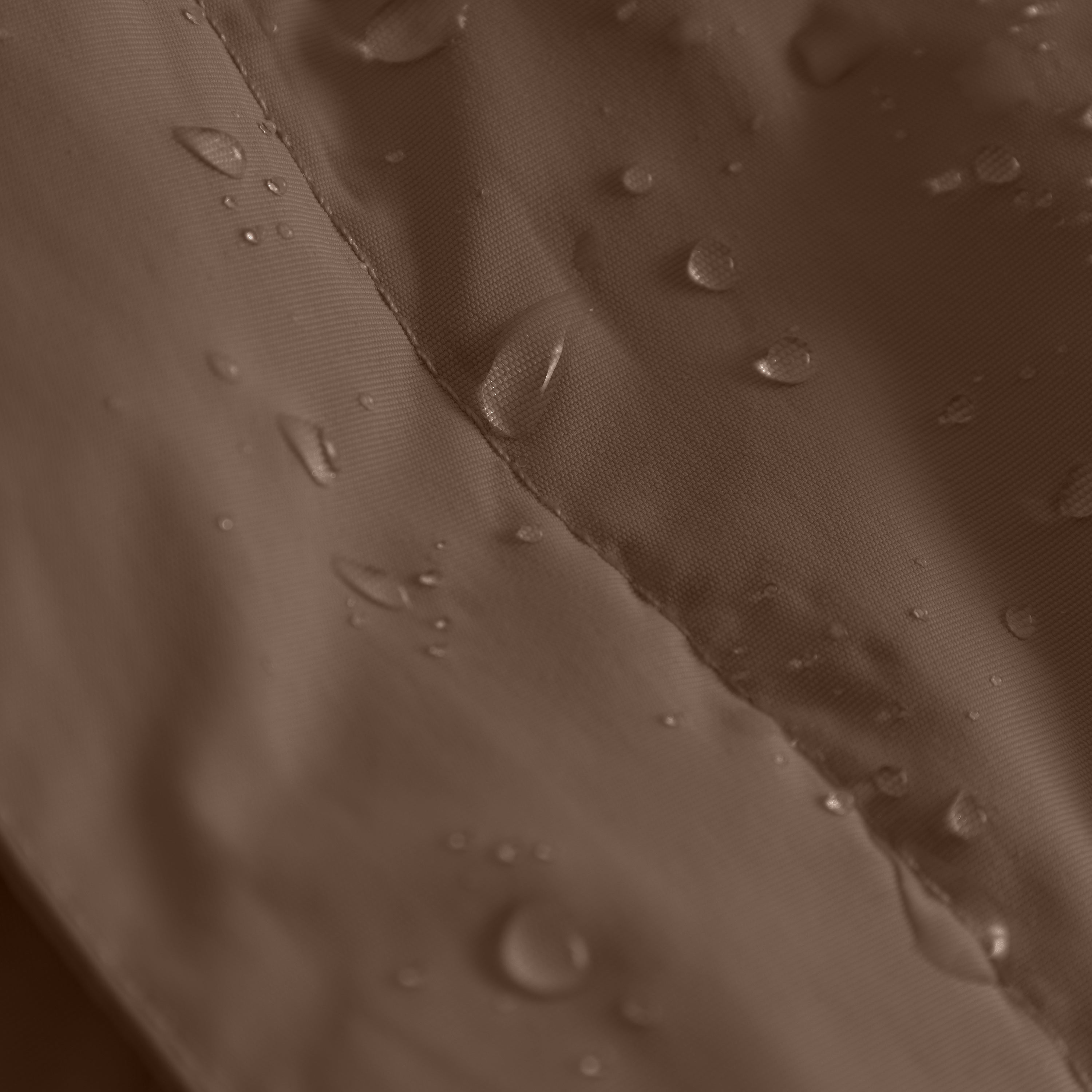 Close-up of the MATWANG fleece-lined winter jacket's waterproof recycled nylon shell in warm brown with water droplets beading on the surface, demonstrating the fluorine-free Bionic Finish Eco treatment, with flat-felled seams visible across the fabric.