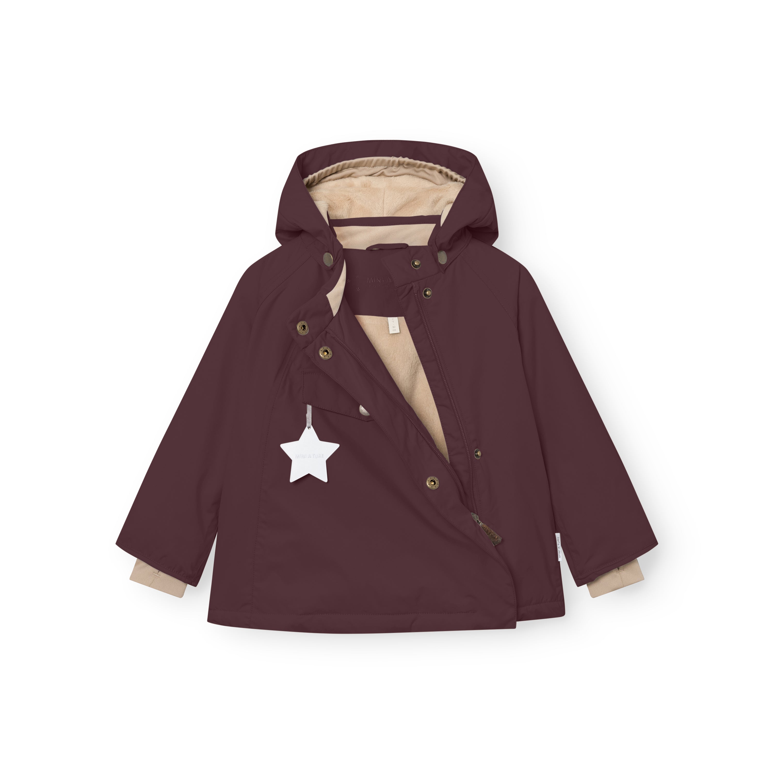 MATWANG fleece-lined winter jacket in deep burgundy laid flat with the hidden slanted front zip partially open, showing the beige fleece lining inside, bronze-toned press-stud fastenings along the concealed chest flap and detachable hood, and a white reflective star hanging from the front pocket.
