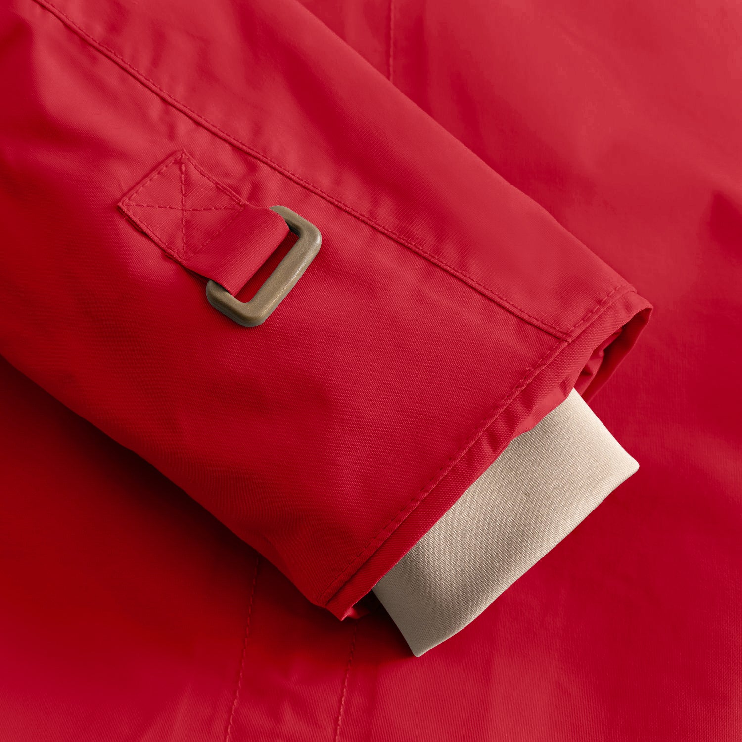 Detail of the MATWALLY fleece lined winter jacket sleeve in red, showing the adjustable snow cuff with metal D-ring and fabric tab, beige ribbed inner cuff extending below the outer sleeve and fully taped seam construction visible along the edge.